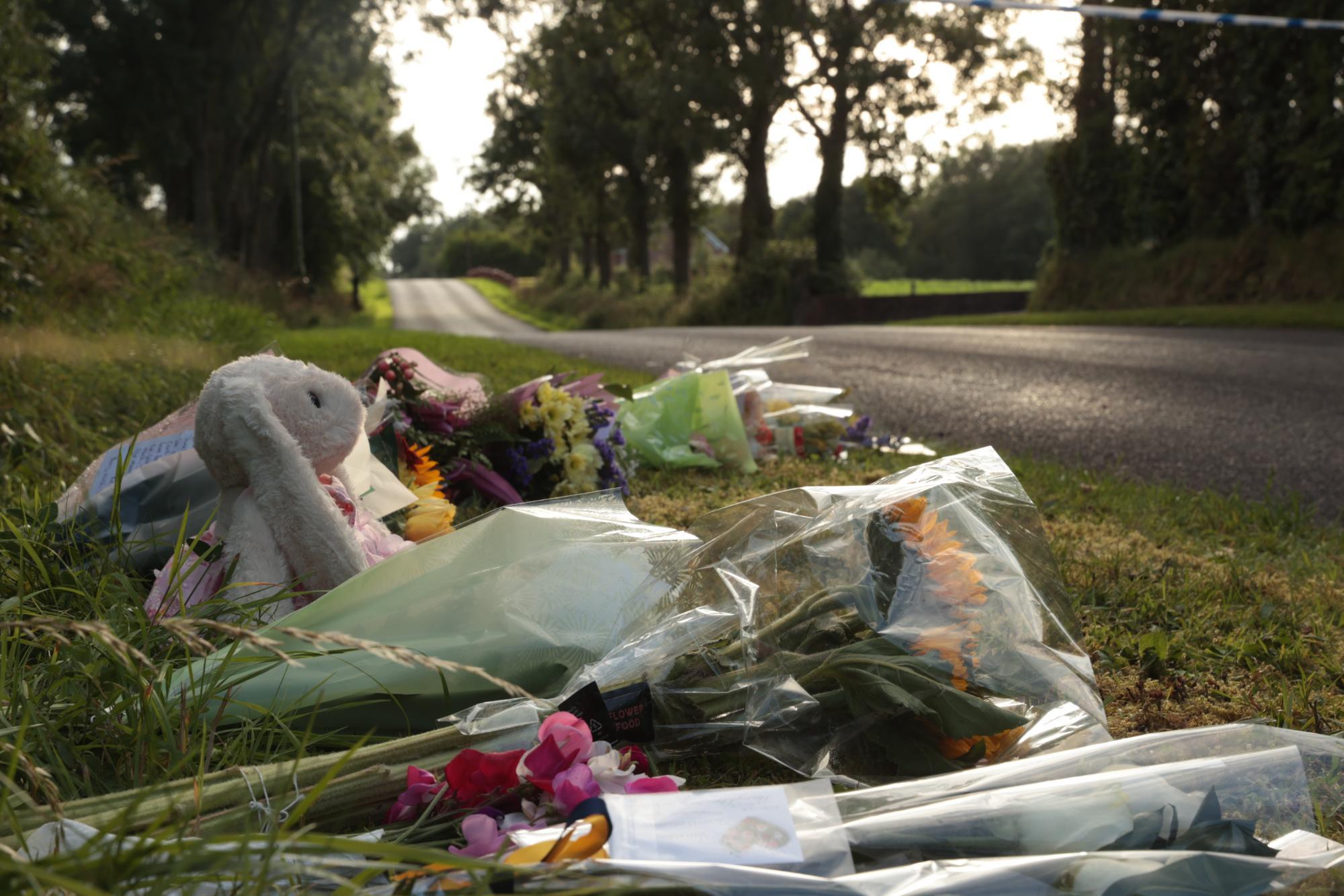 Flowers at a vigil for James Rutledge, Vanessa Whyte, and Sara Rutledge, from a post dated July 26, 2025 | Source: Facebook/irishmirror