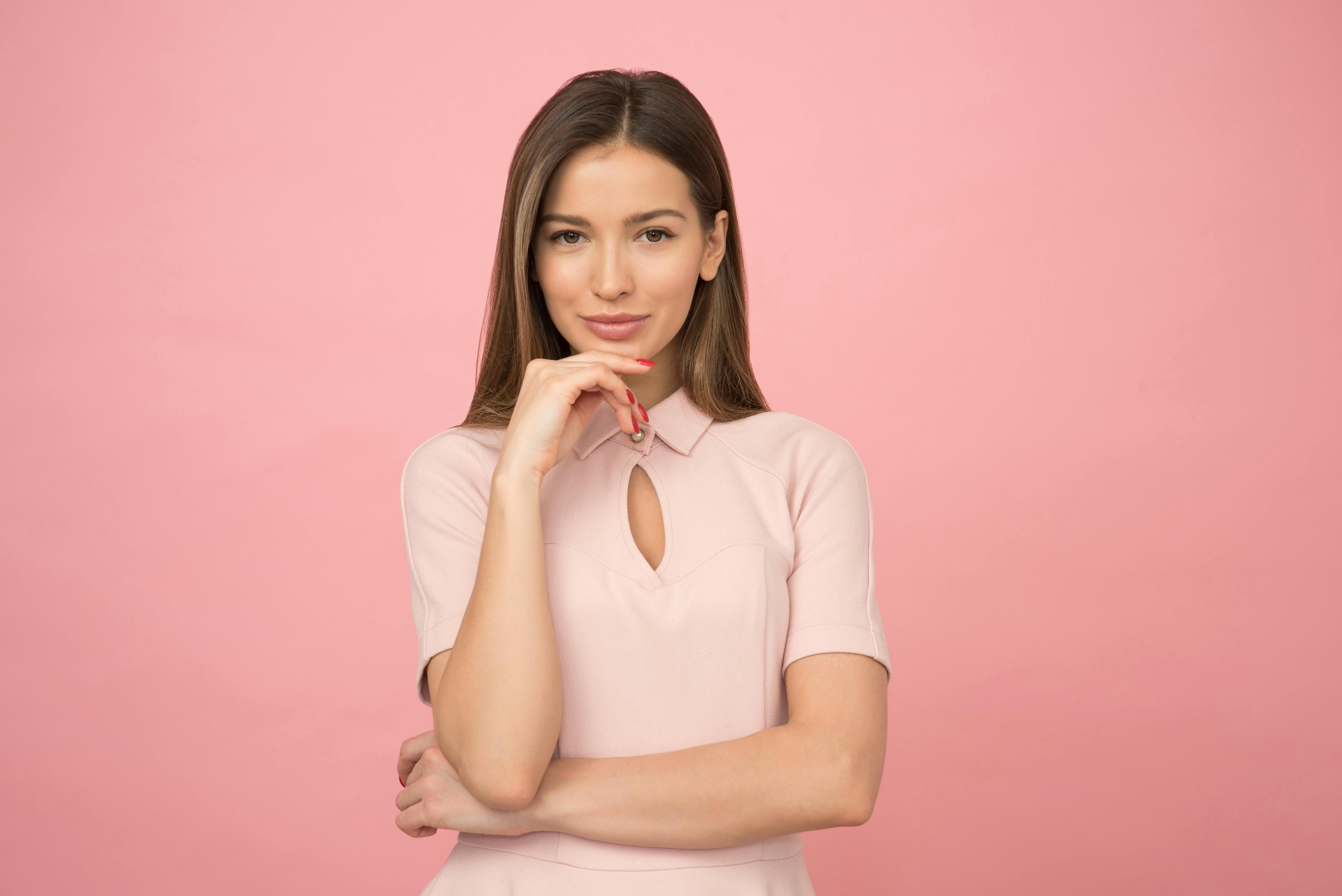 A woman smiling while plotting a plan | Source: Pexels