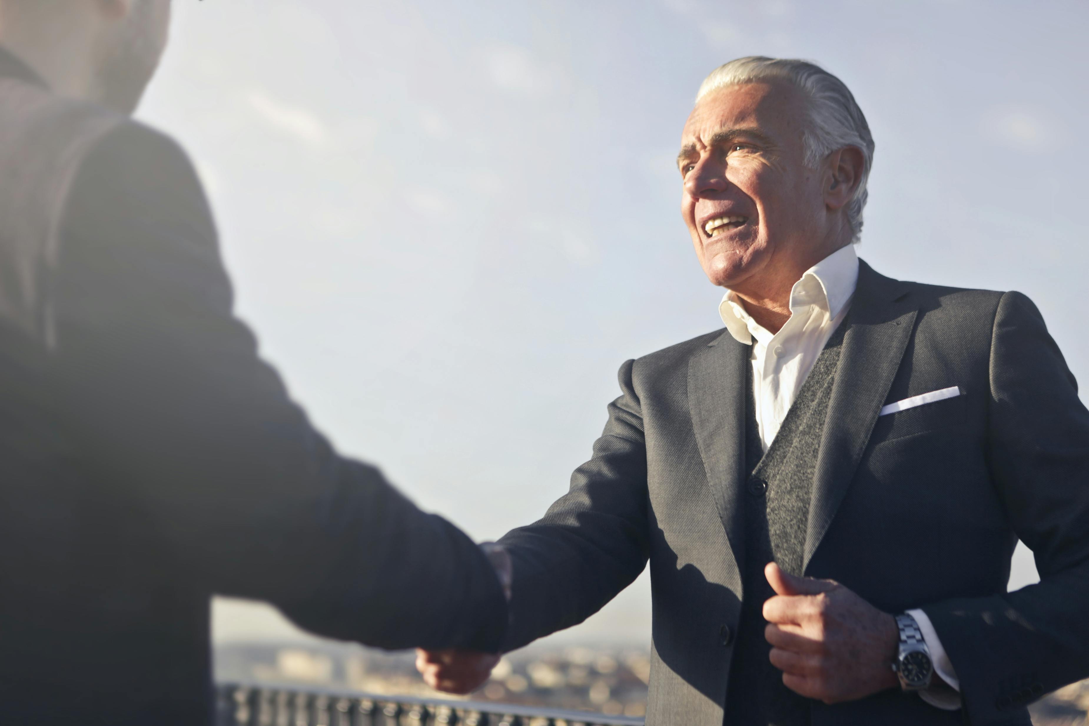 Two men shake hands in introduction  | Source: Pexels