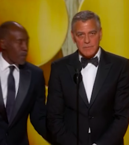 Don Cheadle giving a playful slap to George Clooney's backside. | Source: Instagram/enews