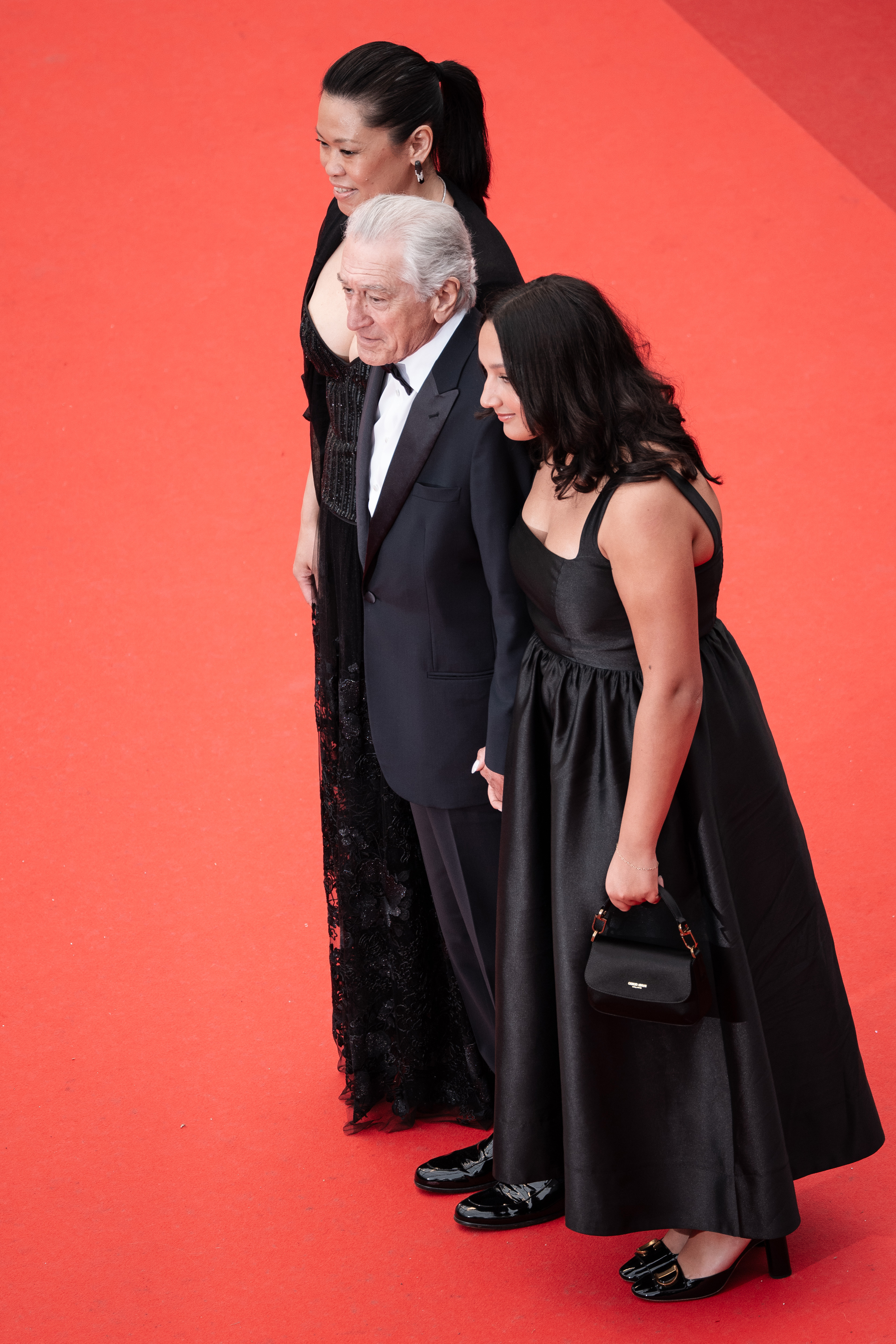 Tiffany Chen, Robert De Niro, and Helen Grace De Niro attend the red carpet at the 78th annual Cannes Film Festival at Palais des Festivals on May 13, 2025, in France | Source: Getty Images