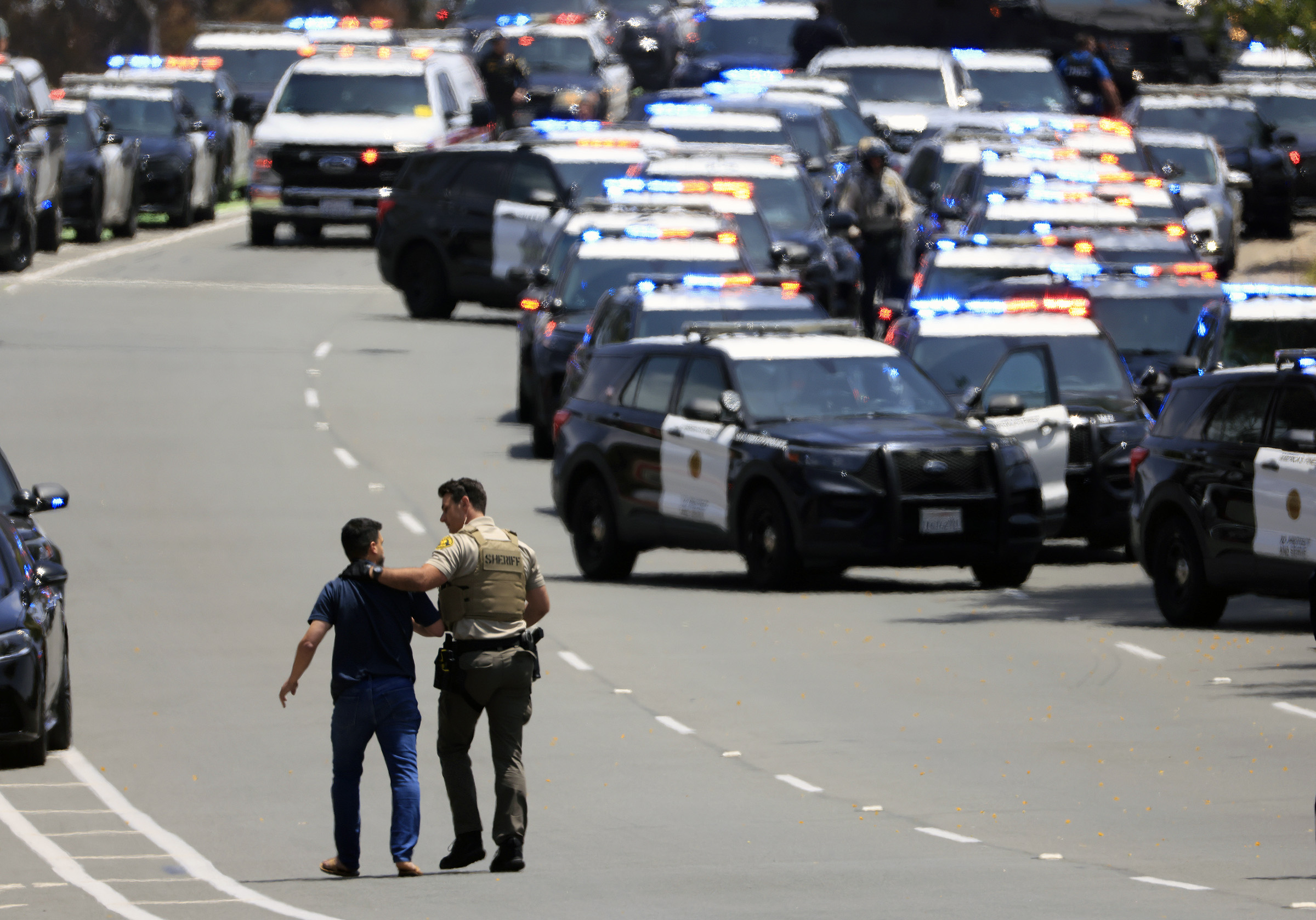 A sheriff's deputy escorts a person away from the area surrounding the Islamic Center of San Diego on May 18, 2026 | Source: Getty Images