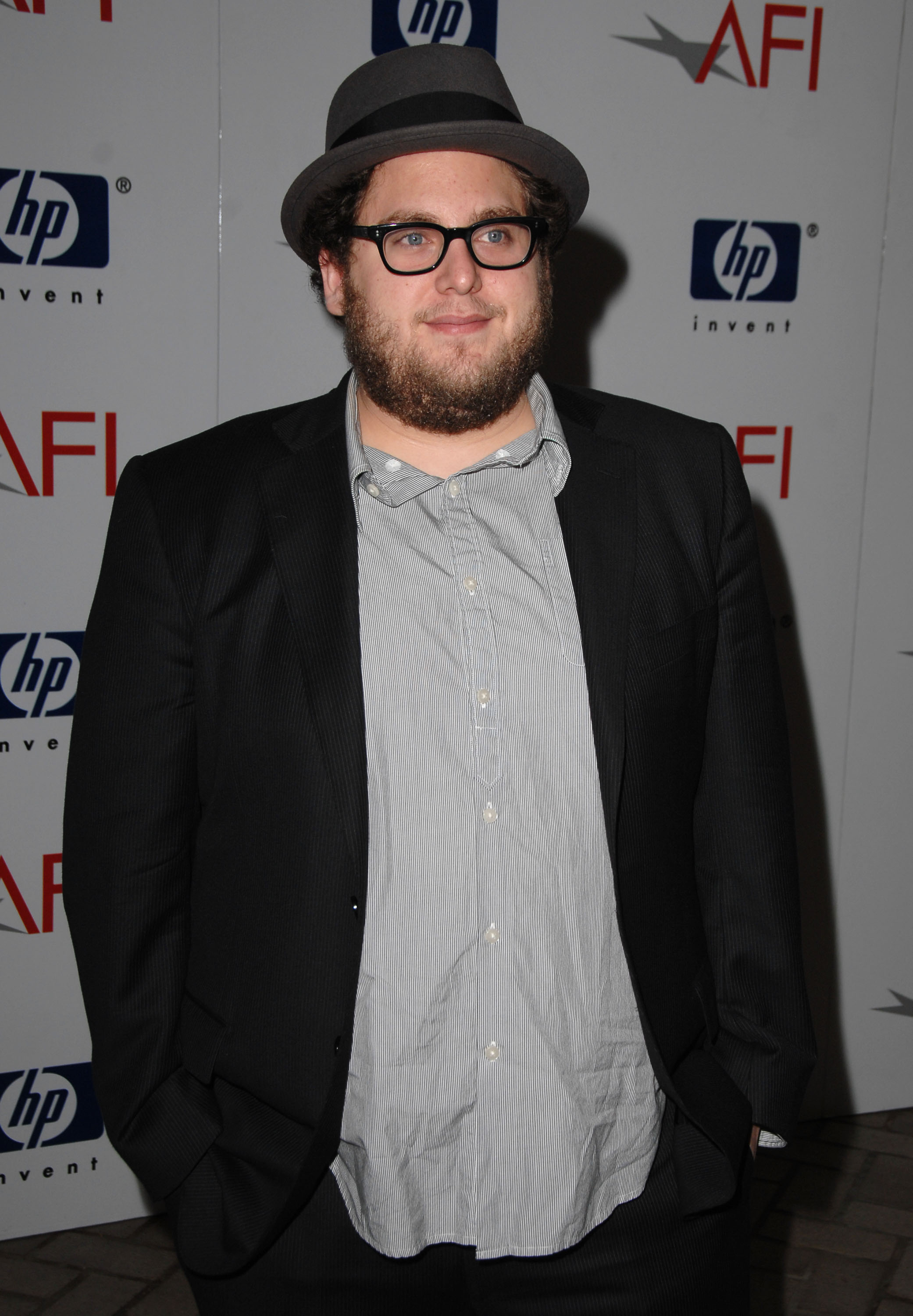 Jonah Hill stepped onto the red carpet for the 2008 AFI Luncheon at the Four Seasons Hotel in Los Angeles on January 11, 2008, several months after "Superbad" established him as a rising comedy star. Sporting a beard, black-framed glasses, and a gray fedora with his hands tucked casually into his pockets, Hill retained the fuller physique of his breakout period before his first major weight loss became visible a few years later.