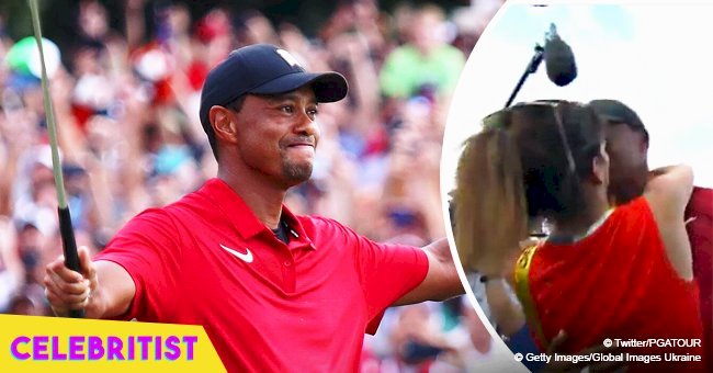 Tiger Woods celebrates his first win in five years with a kiss from girlfriend