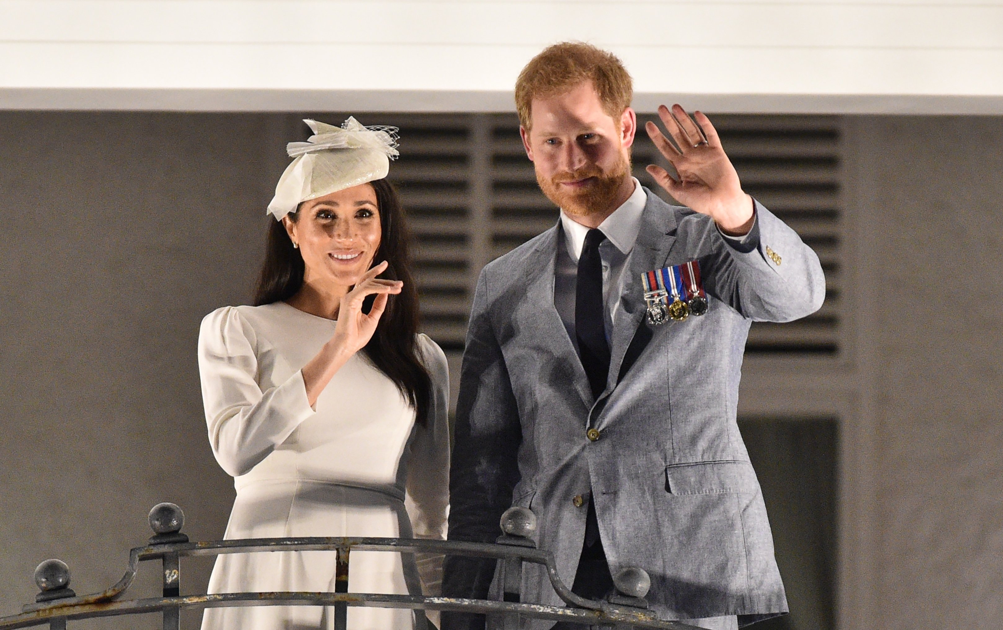 Prince Harry and his wife Meghan Markle pictured waving from the balcony of the Grand Pacific Hotel on October 23, 2018 in Suva, Fiji. | Source: Getty Images