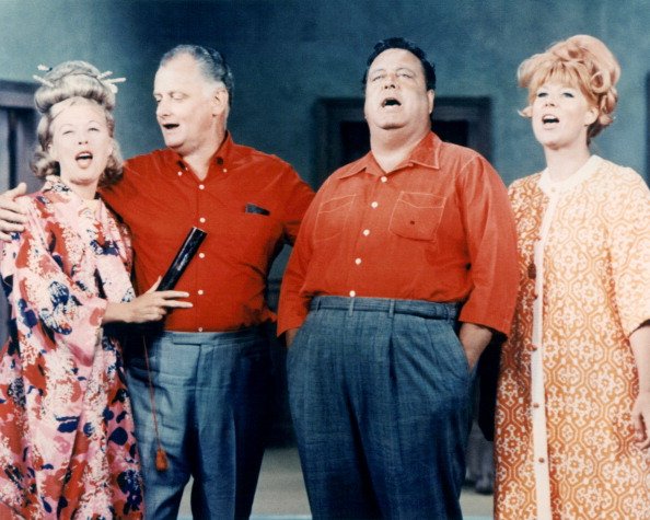 Joyce Randolph, Art Carney, Jackie Gleason, and Audrey Meadows stand in a group singing, circa 1955. | Photo: Getty Images