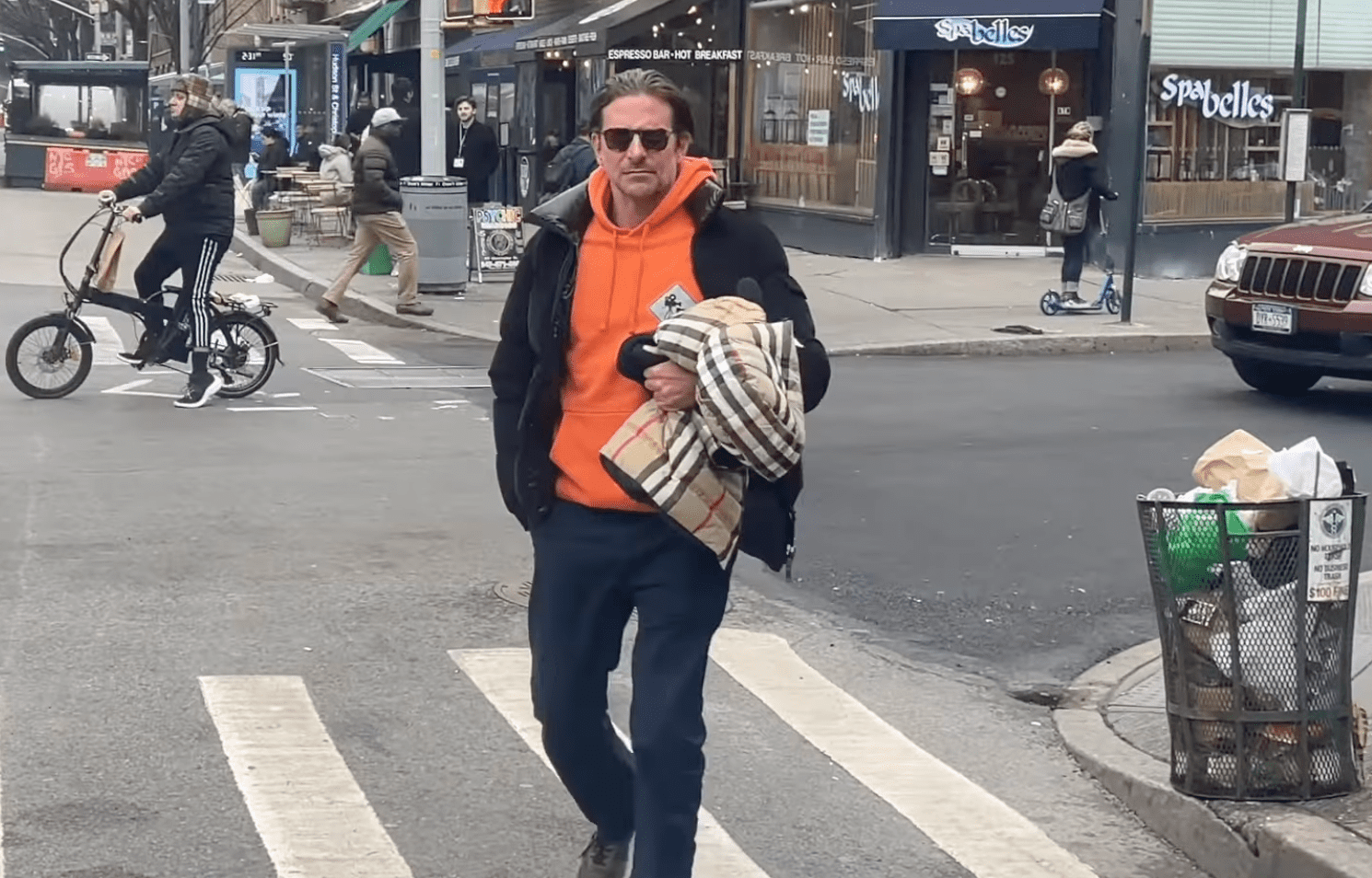 Bradley Cooper seen walking while holding a small coat in New York City on January 5, 2023 | Source: YouTube/The Hollywood Fix