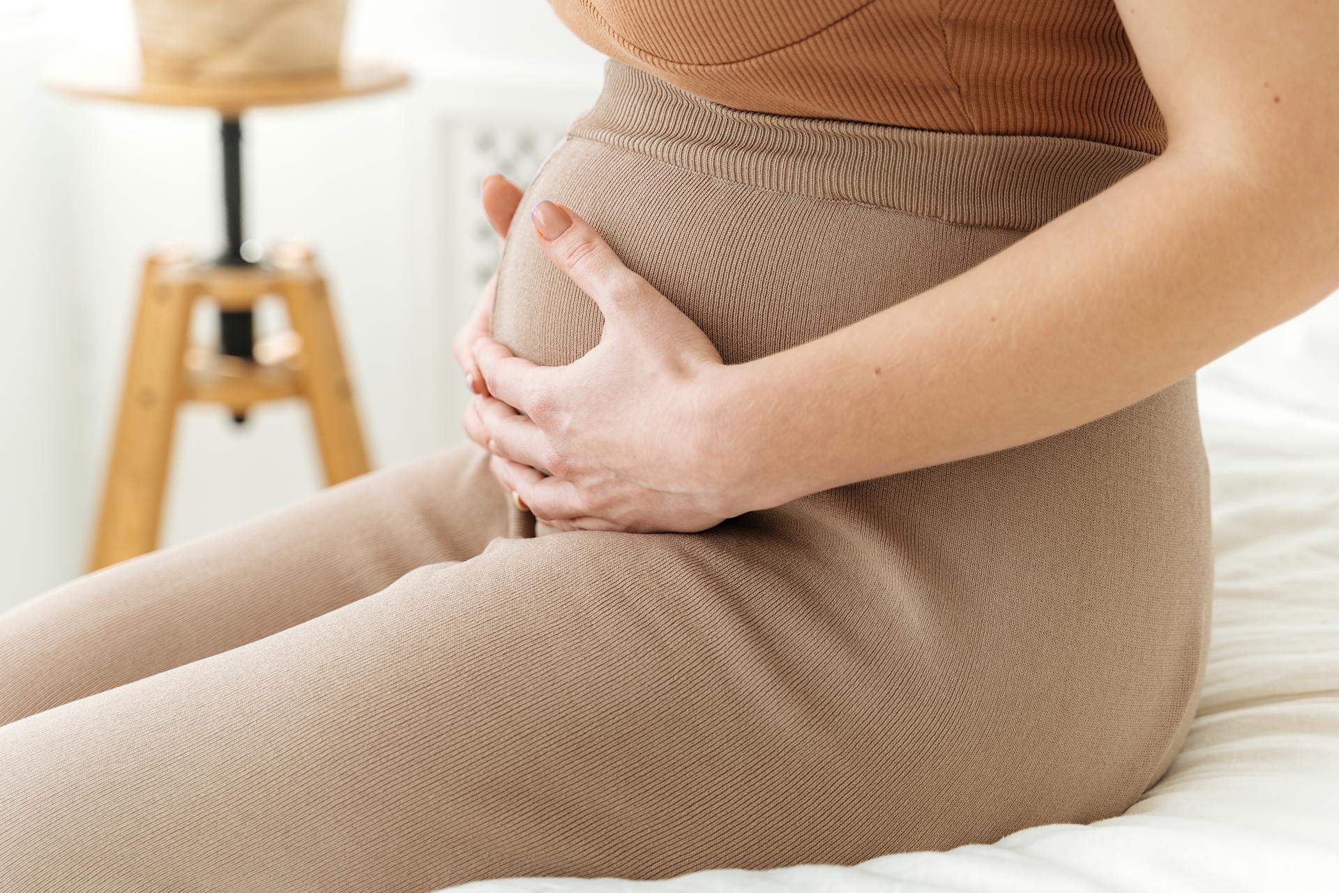 A closeup shot of a woman holding her baby bump | Source: Pexels