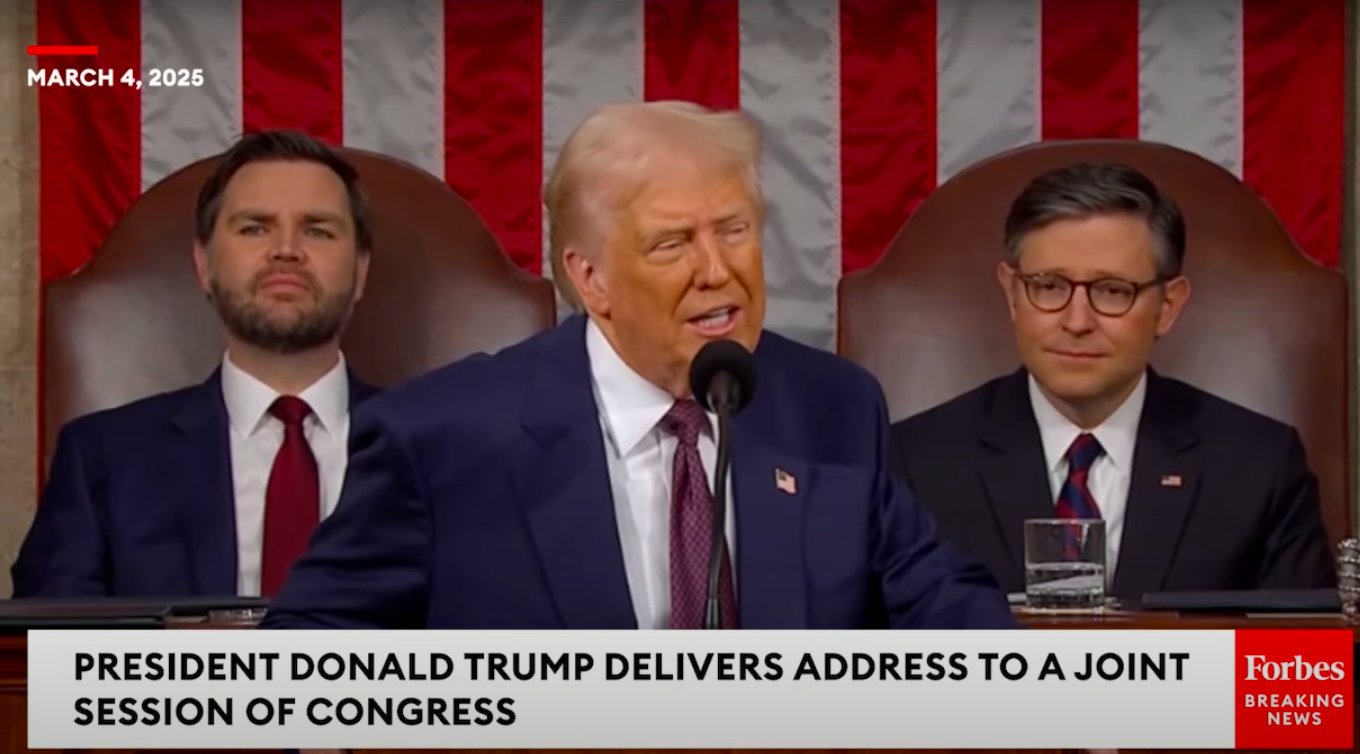 President Donald Trump acknowledging First Lady Melania Trump during his address to Congress with Vice President JD Vance and another political figure seated behind him, posted on March 5, 2025. | Source: YouTube/Forbes Breaking News