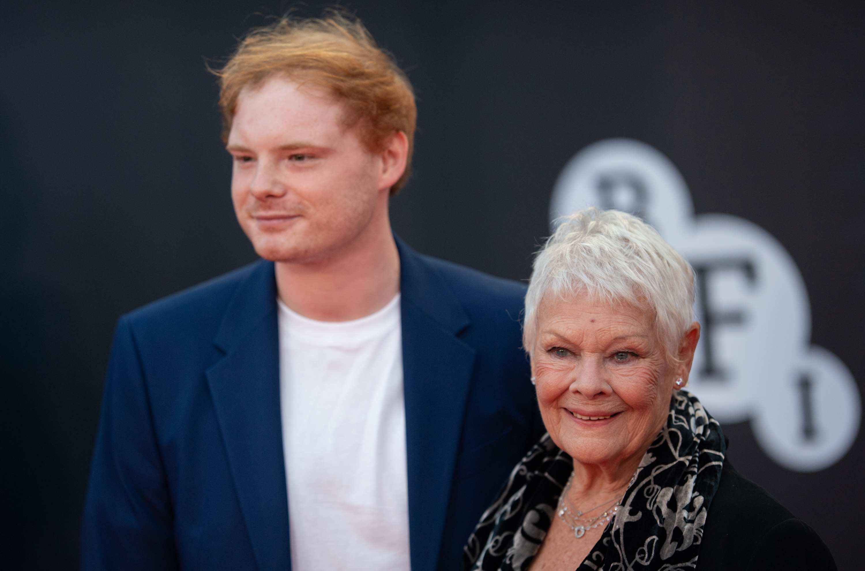 Dame Judi Dench and Sam Williams attend the "No Time To Die" World Premiere at Royal Albert Hall in London, England, on September 28, 2021. | Source: Getty Images