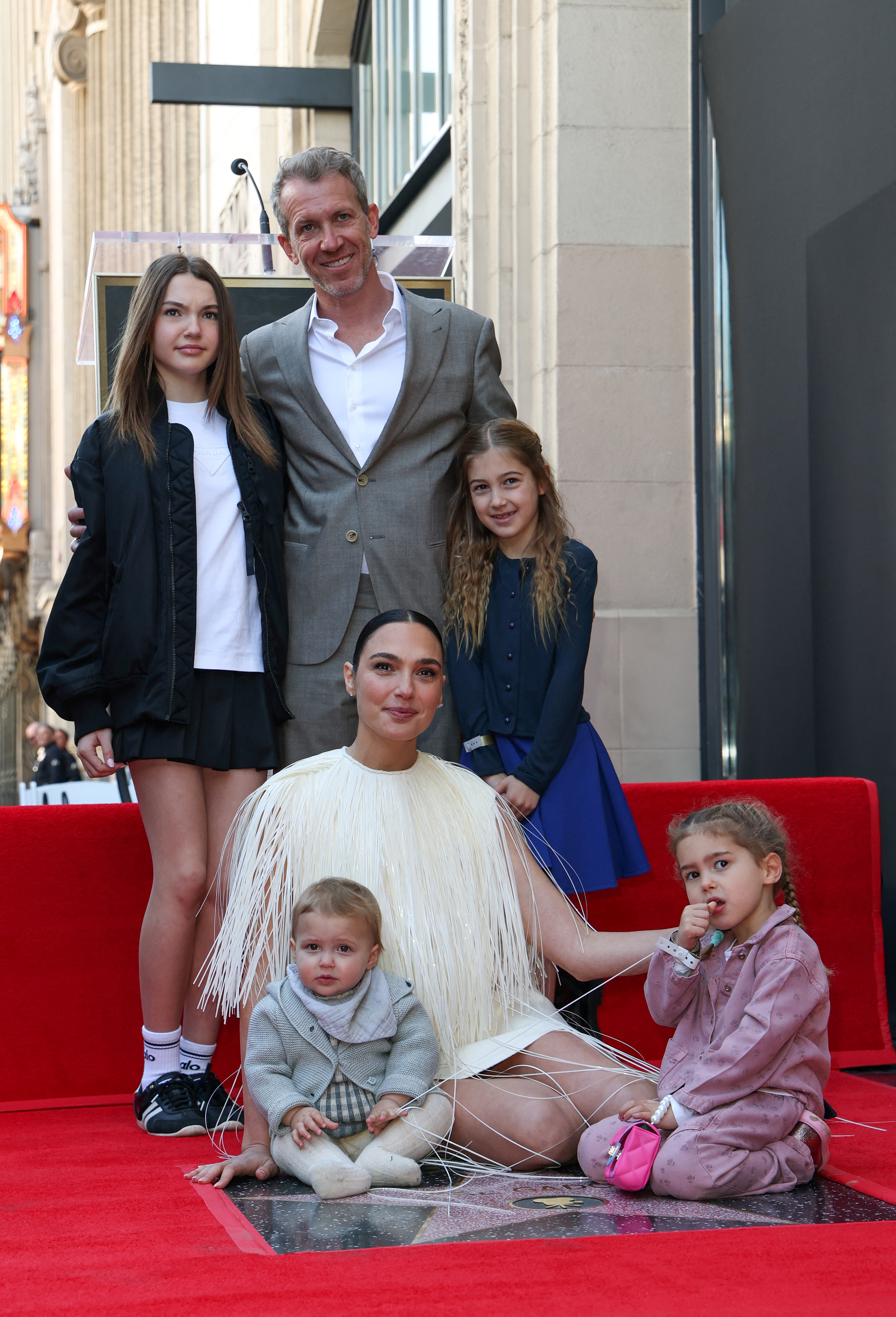 Israeli actress Gal Gadot and her family (L-R) Alma Varsano, Jaron Varsano, Ori Varsano, Maya Varsano, and Daniella Varsano attend her Hollywood Walk of Fame Star Ceremony in front of El Capitan in Los Angeles, California, on March 18, 2025 | Source: Getty Images