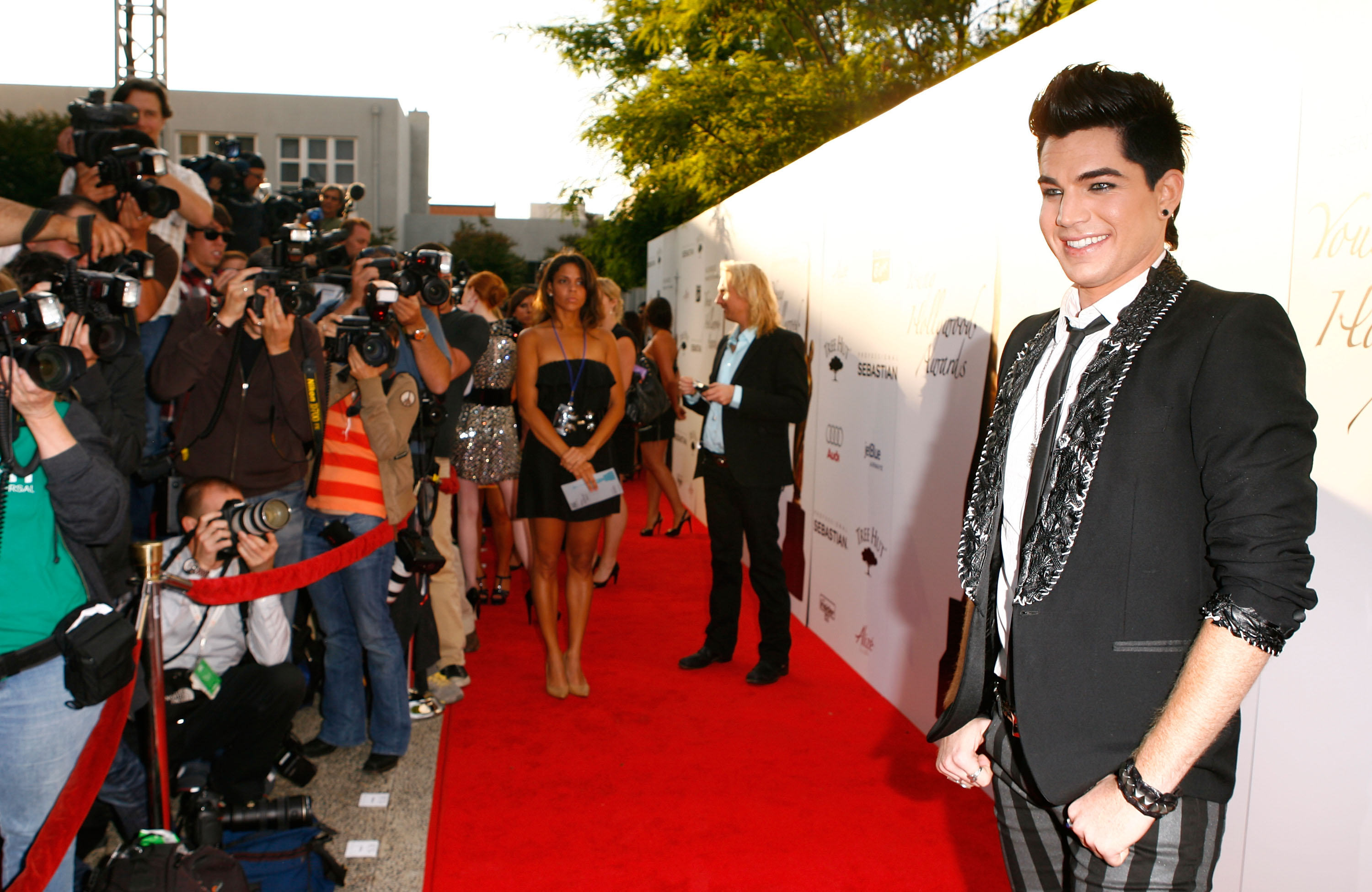 Adam Lambert arrives at the 11th Annual Young Hollywood Awards on June 7, 2009, in Santa Monica. Wearing bold striped pants and a decorative black blazer, his look — complete with eyeliner — signals the early evolution of his now-signature glam persona.