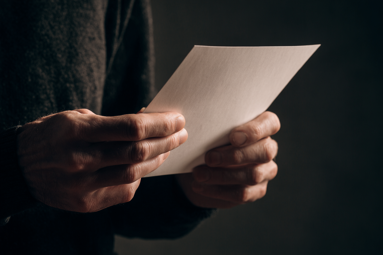 A man holding a paper | Source: Midjourney
