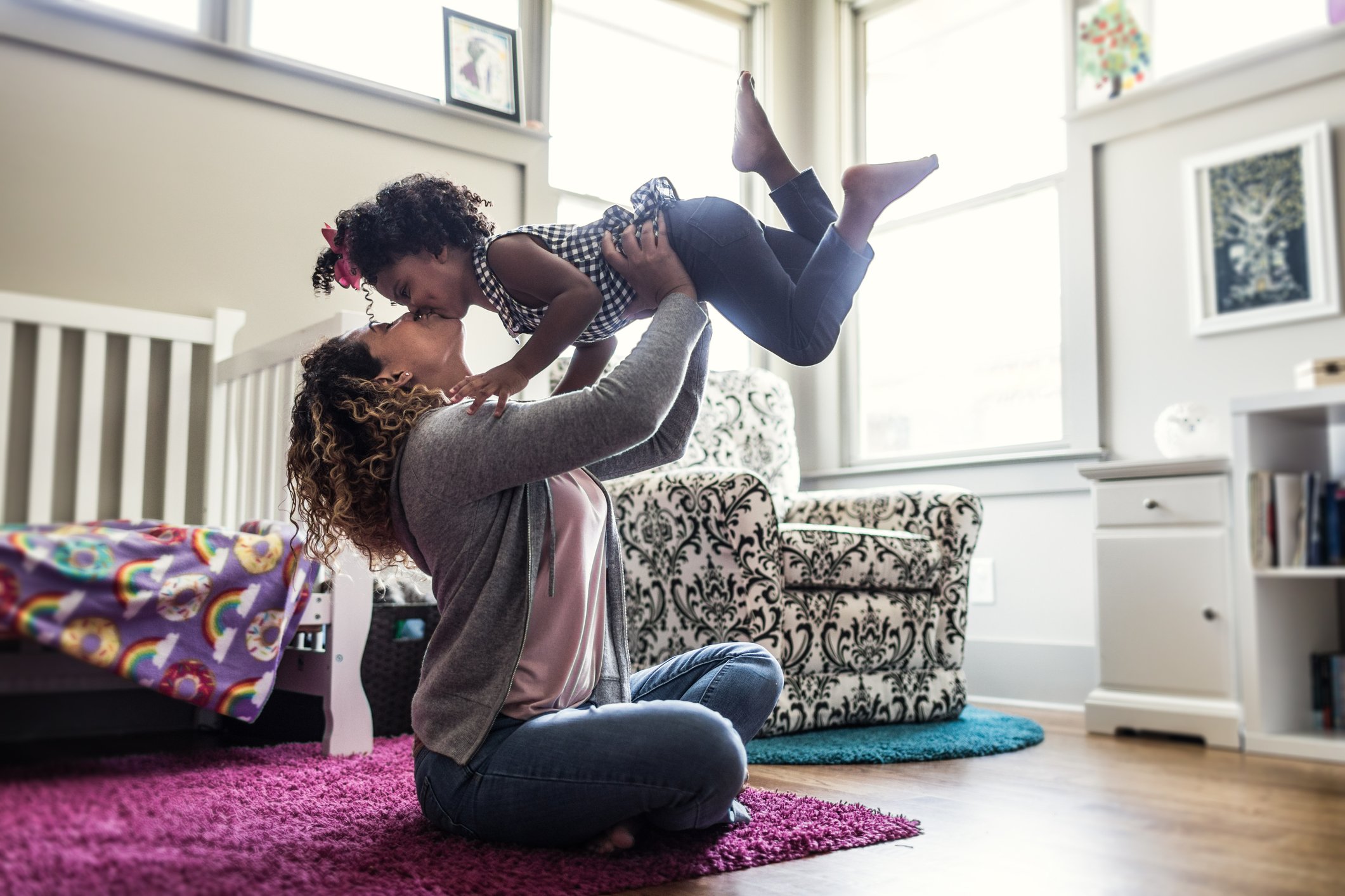 Mother and daughter playing on bedroom floor | Photo: Getty Images