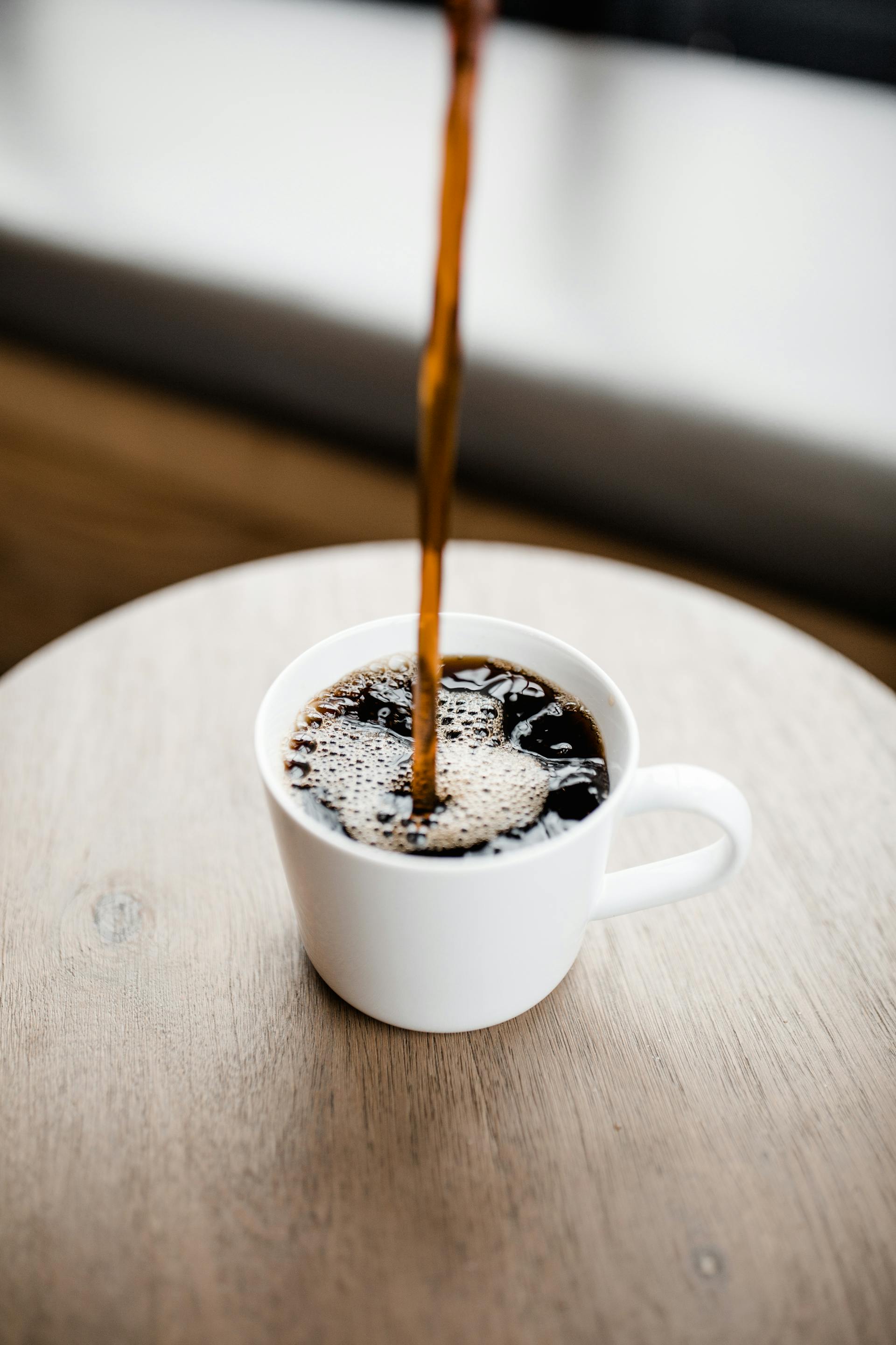 Coffee being poured into a cup | Source: Pexels