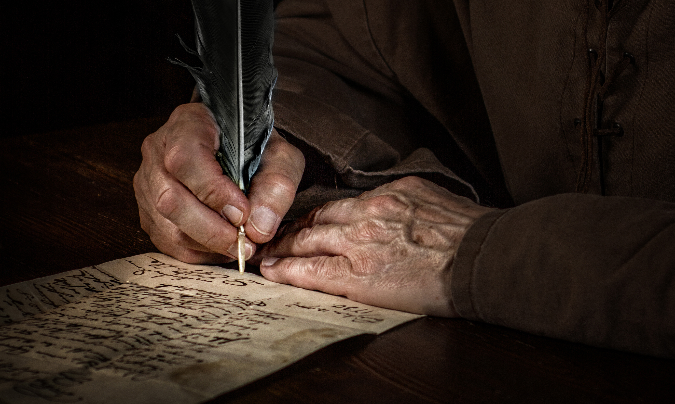 Man is writing in the darkness | Source: Shutterstock.com