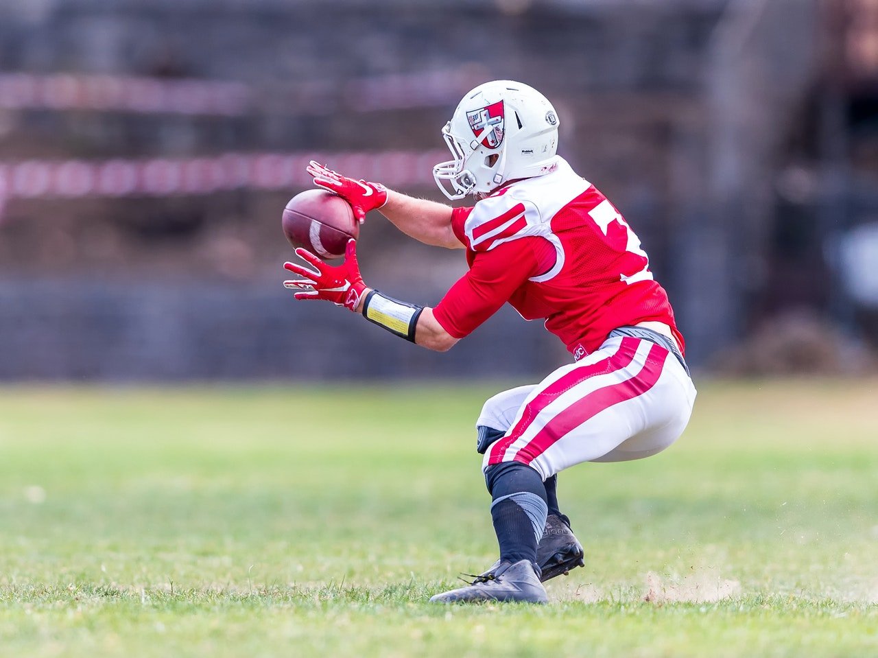Photo of a football player catching a ball | Photo: Pexels