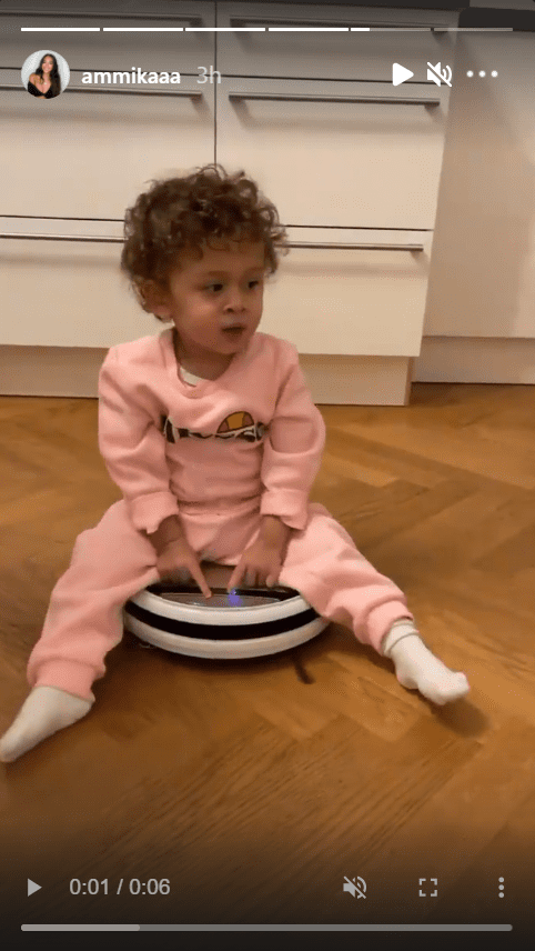 Screenshot of video of Aeko Catori Brown riding a robot vacuum cleaner.| Source: Instagram/ammikaaa