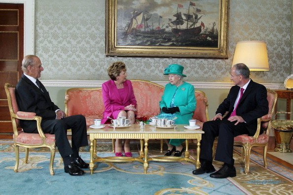 Prince Philip The Duke of Edinburgh, President Mary Mc Aleese, Queen Elizabeth II and Dr Martin Mc Aleese talk over a cup of tea at Aras An Uachtarain on May 17, 2011, in Dublin,Ireland. | Source: Getty Images.