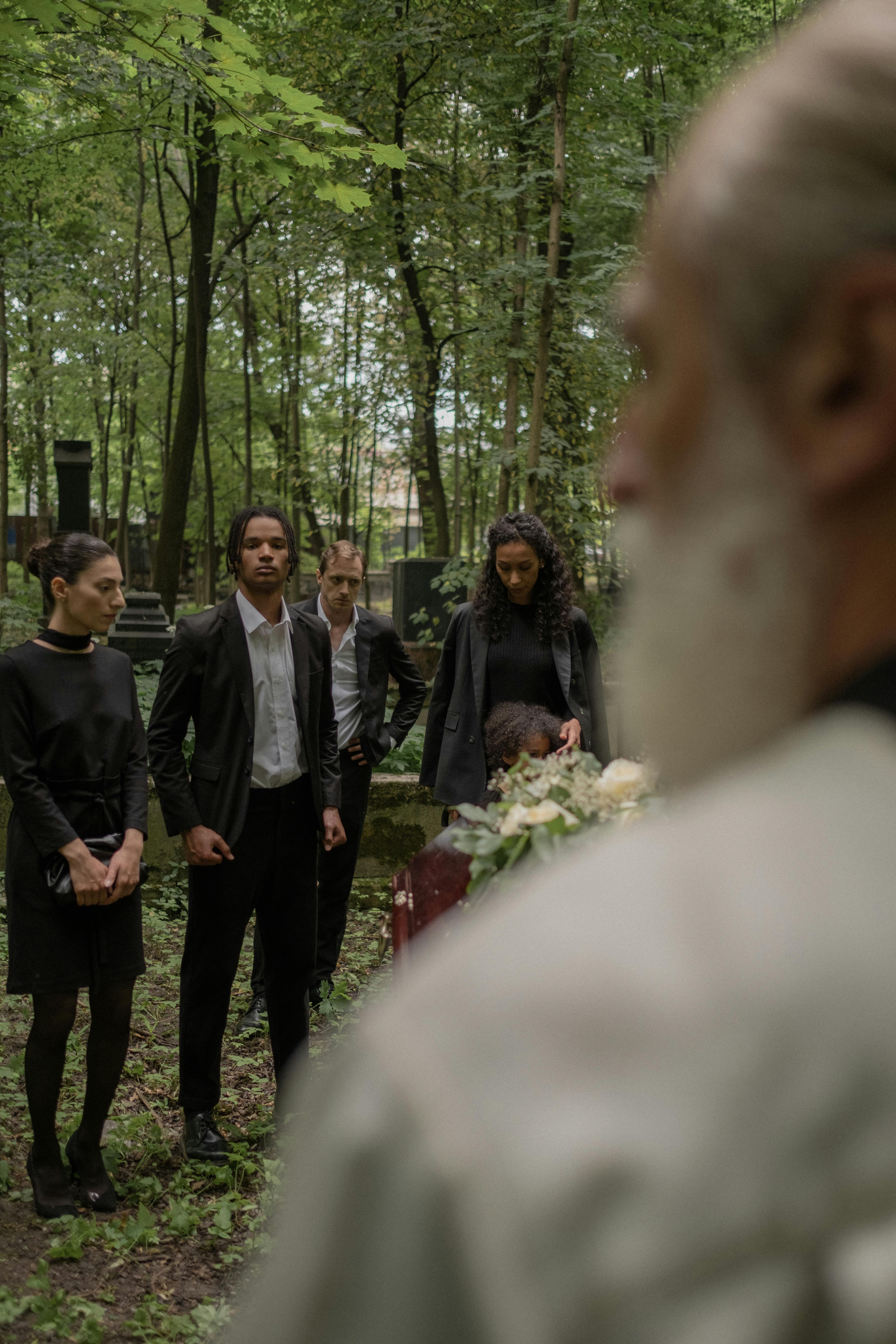 People standing in a cemetery | Source: Pexels