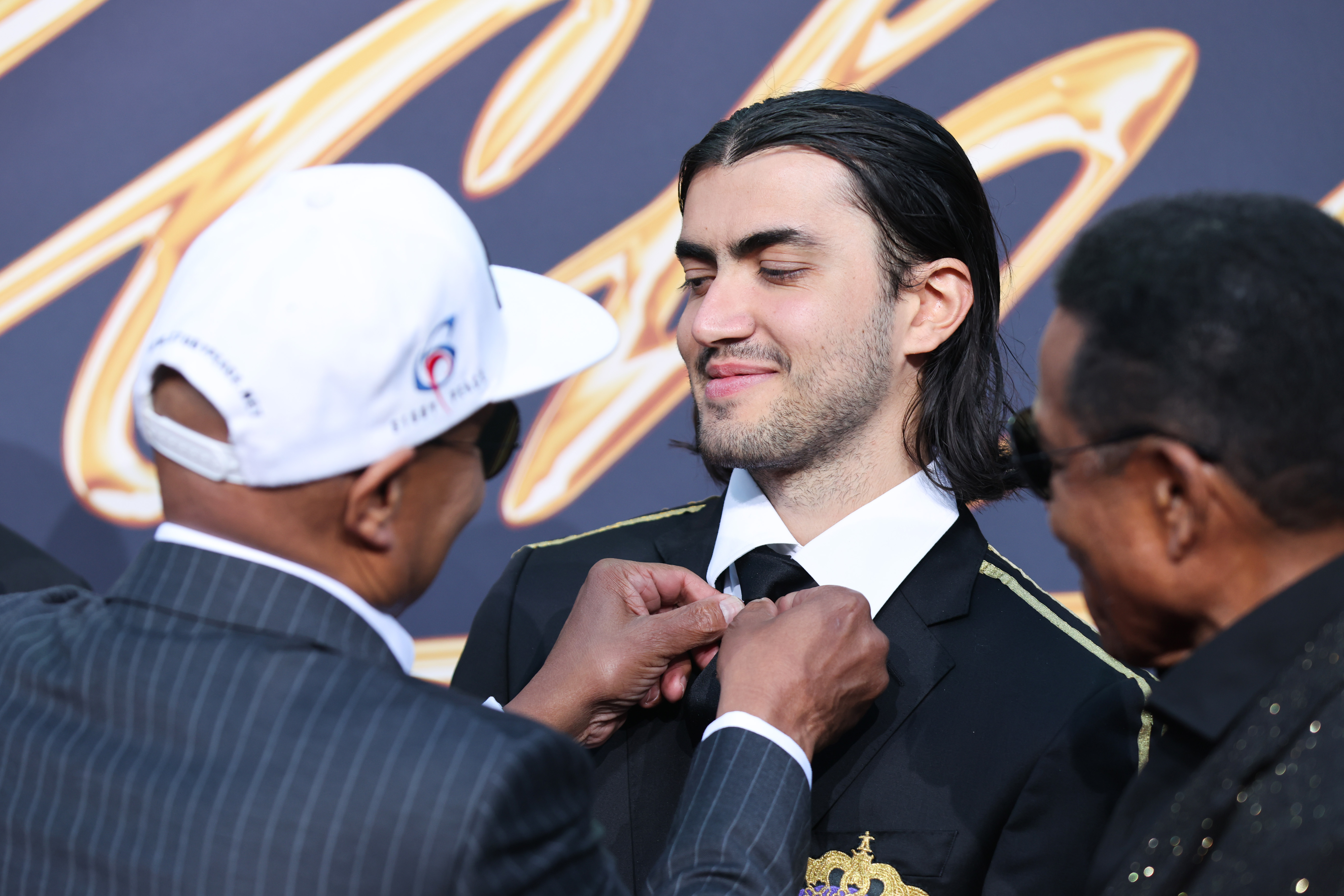 Bigi Jackson getting help from his uncles at the "Michael" premiere at Uber Eats Music Hall on April 10, 2026, in Berlin, Germany.