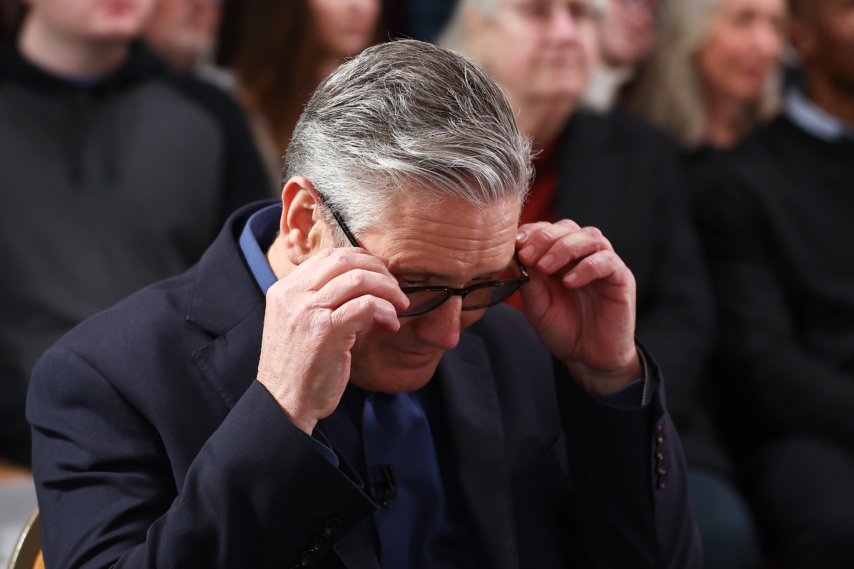 Prime Minister Keir Starmer adjusts his glasses as he waits to deliver his speech at Horntye Park Sports Complex on 5 February 2026 in St Leonards-on-Sea, United Kingdom. | Source: Getty Images
