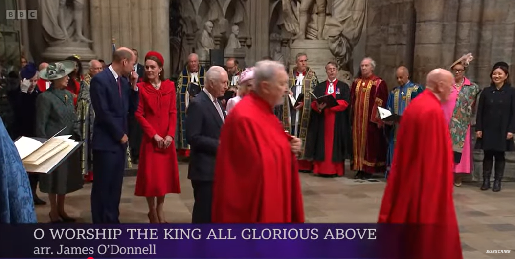 Prince William covers his mouth while whispering something to Princess Catherine | Source: YouTube/BBC