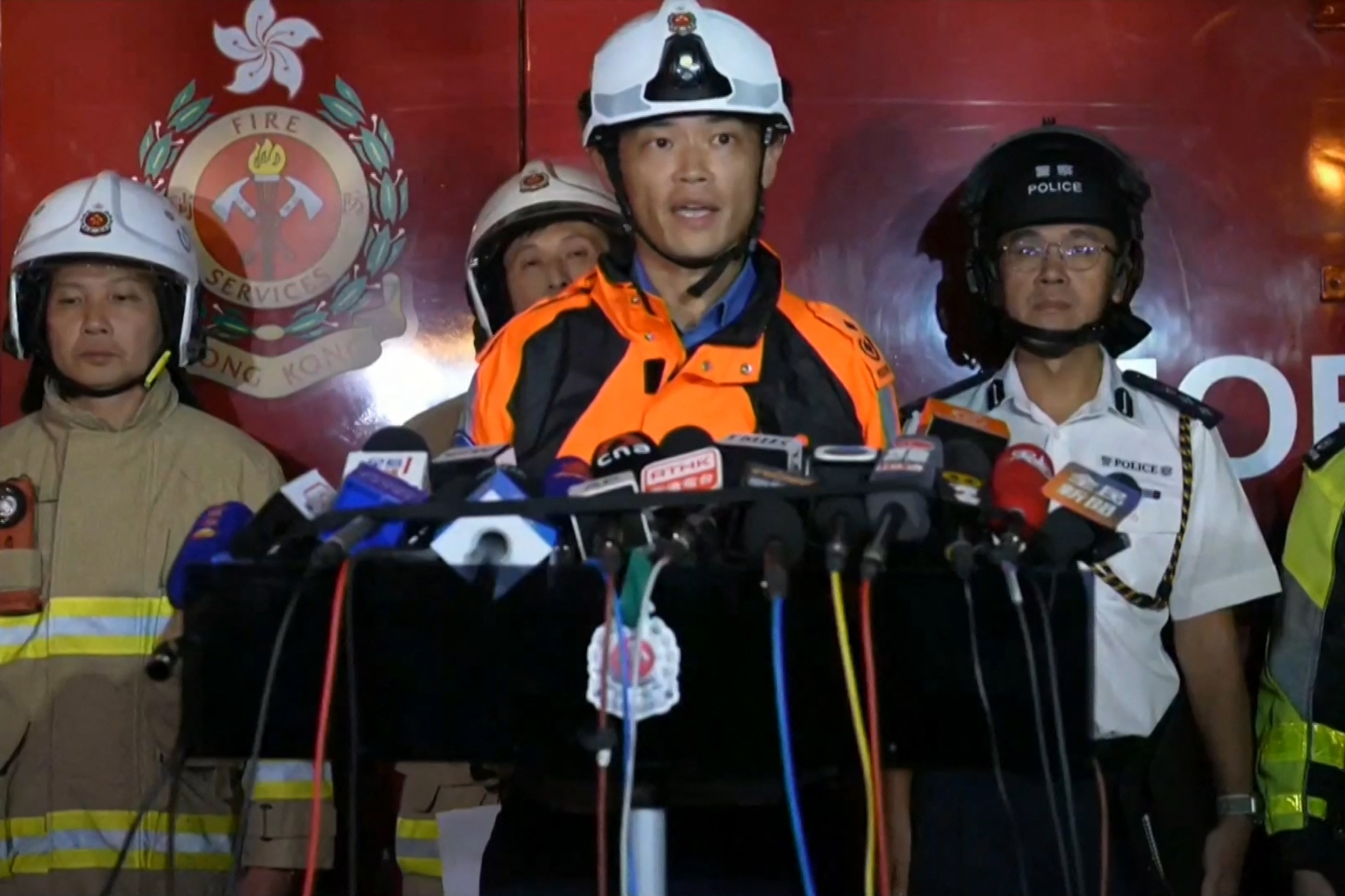Chou Wing-yin, assistant chief ambulance officer (New Territories East), speaking to media amid ongoing operations to control a major fire at the Wang Fuk Court residential estate in Hong Kong's Tai Po district on November 26, 2025. | Source: Getty Images