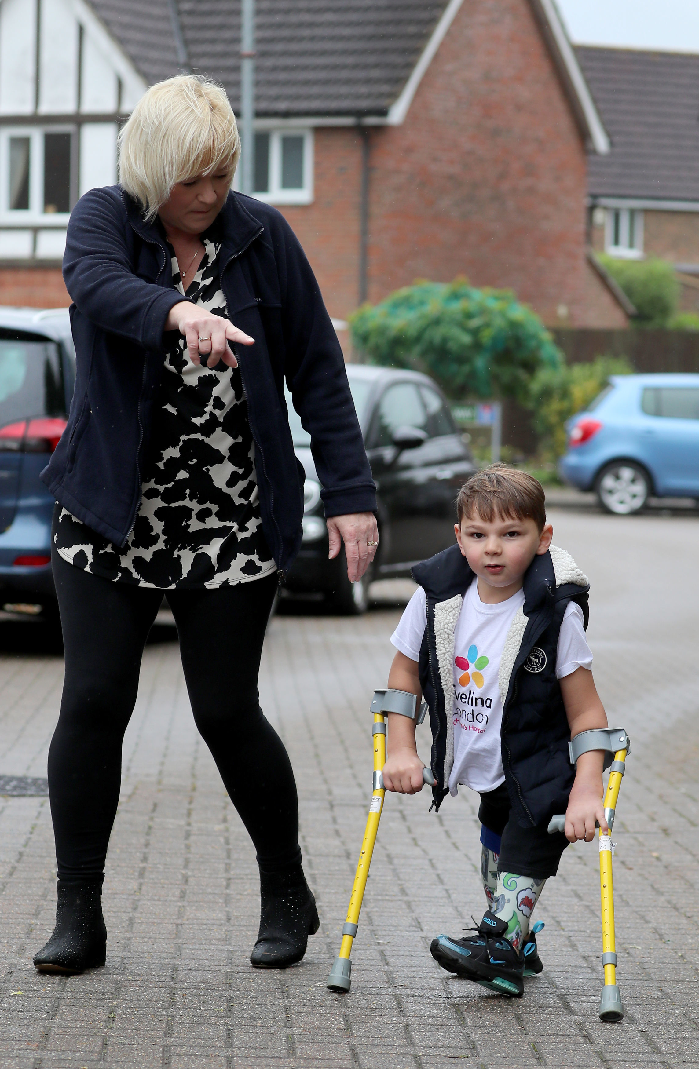 Tony Hudgell, alongside his mother, Paula Hudgell, takes the final steps in his fundraising walk on 30 June 2020 in Kent, England. | Source: Getty Images