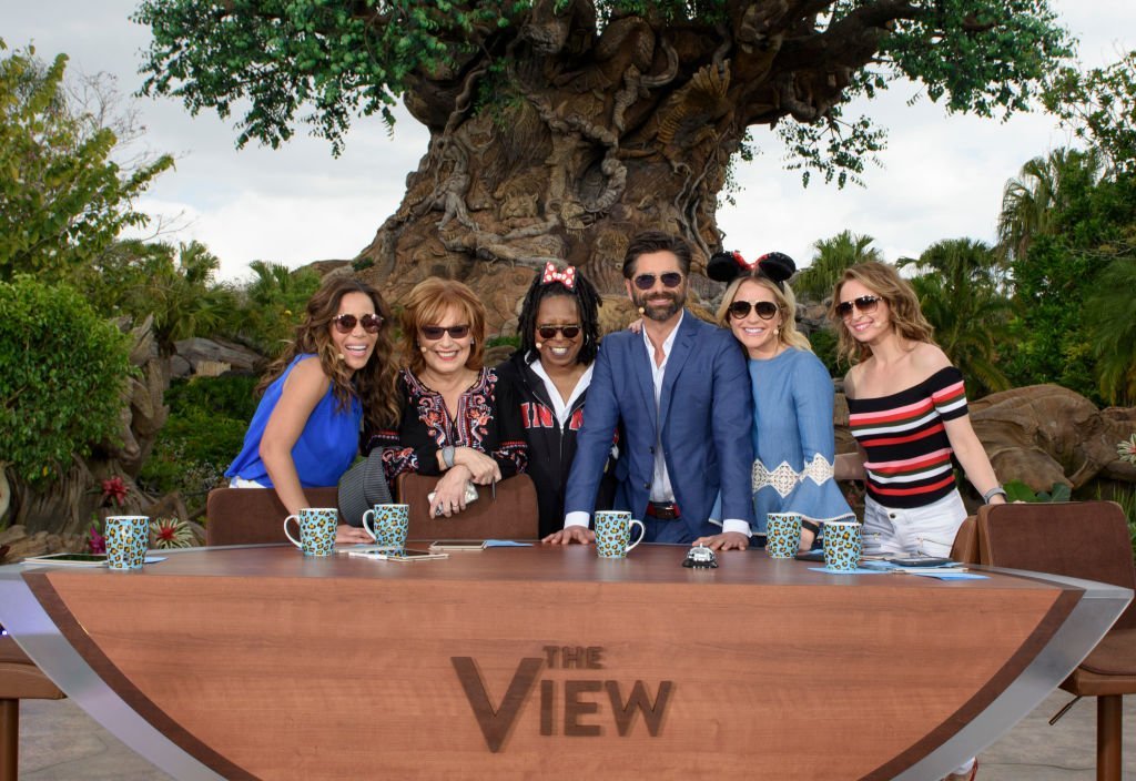 Co-hosts of "The View" pose with Sara Haines, John Stamos and Jedediah Bila in Lake Buena Vista, Florida on March 6, 2017 | Photo: Getty Images