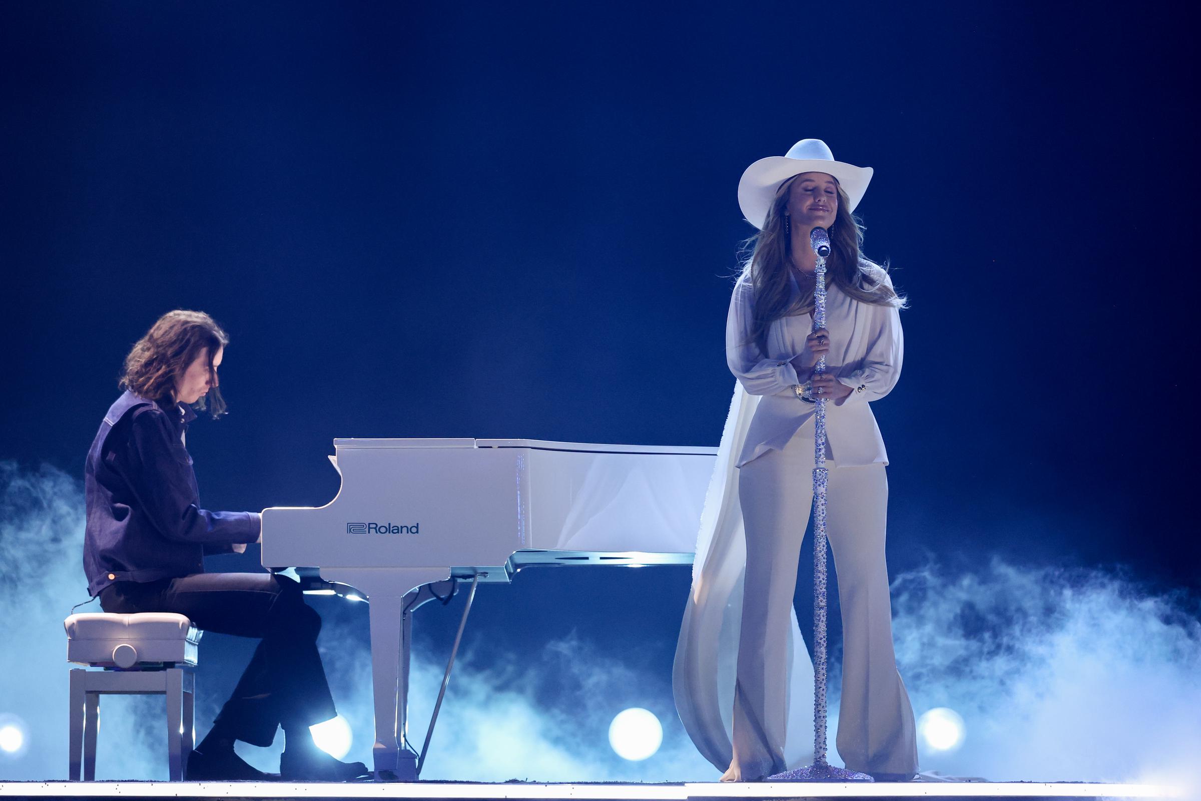 With her eyes closed and a slight smile on her face, Wilson stands still, holding her mic stand with both hands. There’s a stillness in the moment so serene, it feels as though she’s alone in the room, lost entirely in the music.