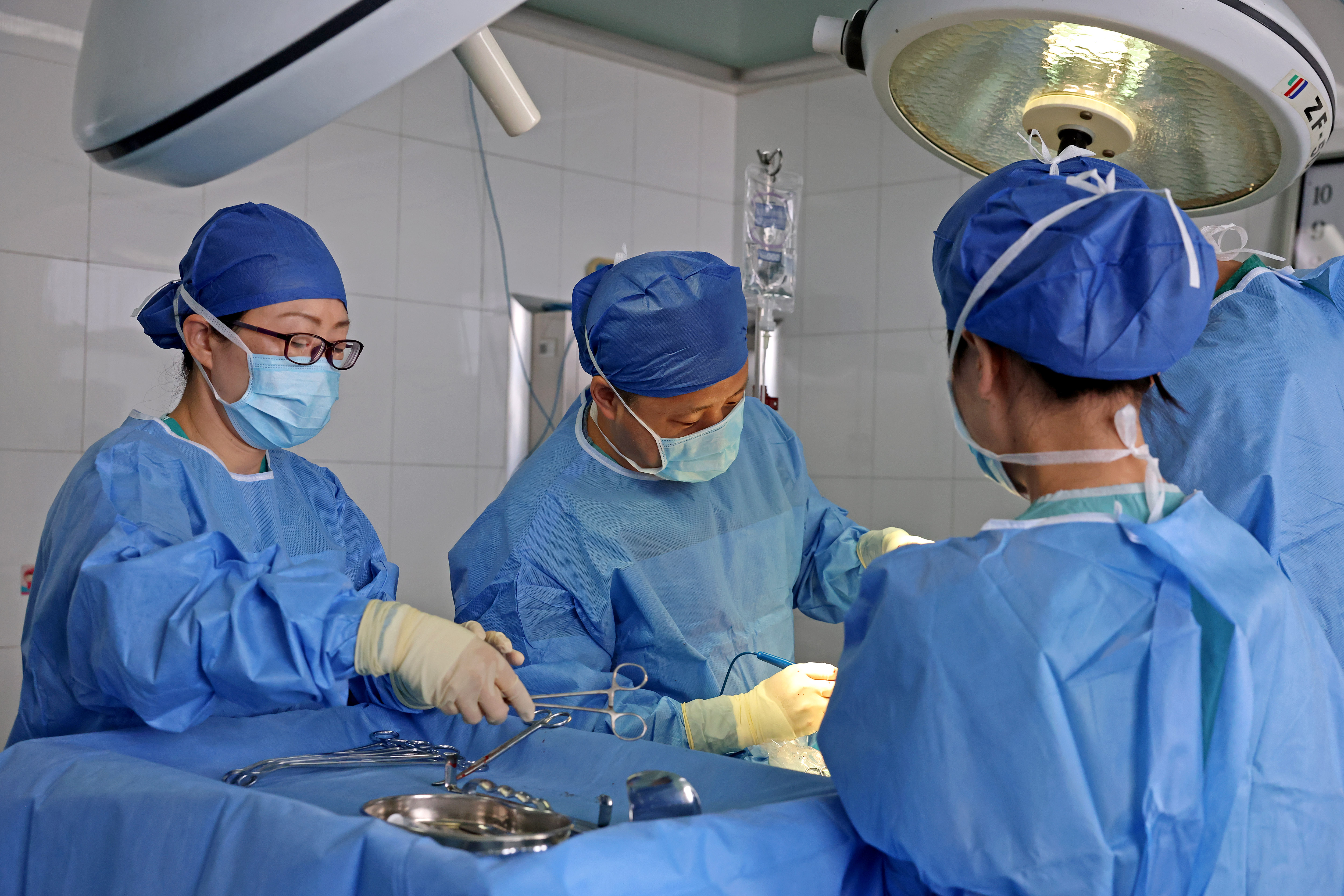 A chief doctor performs a cesarean section on a pregnant woman in the operating room of the Maternity and Child Health Hospital in Zaozhuang, Shandong province, on August 19, 2024 | Source: Getty Images