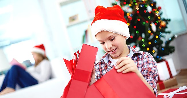 An excited boy opening his gift | Photo: Shutterstock