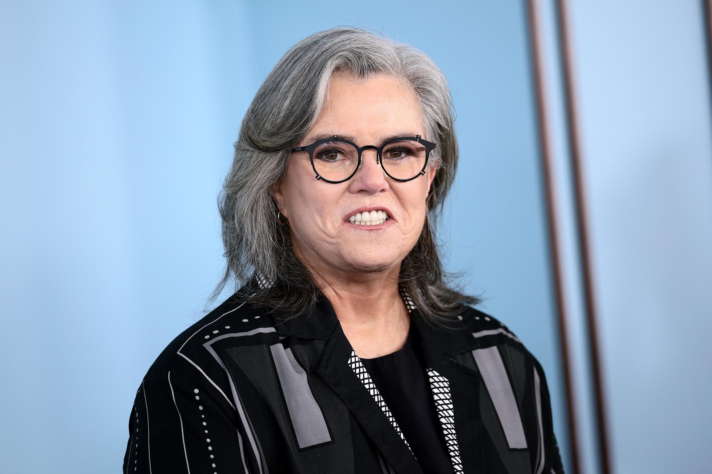 Rosie O'Donnell smiles while posing for photographers near the Tony Awards backdrop. By the end of the night, photos like this had become a major topic of conversation online.