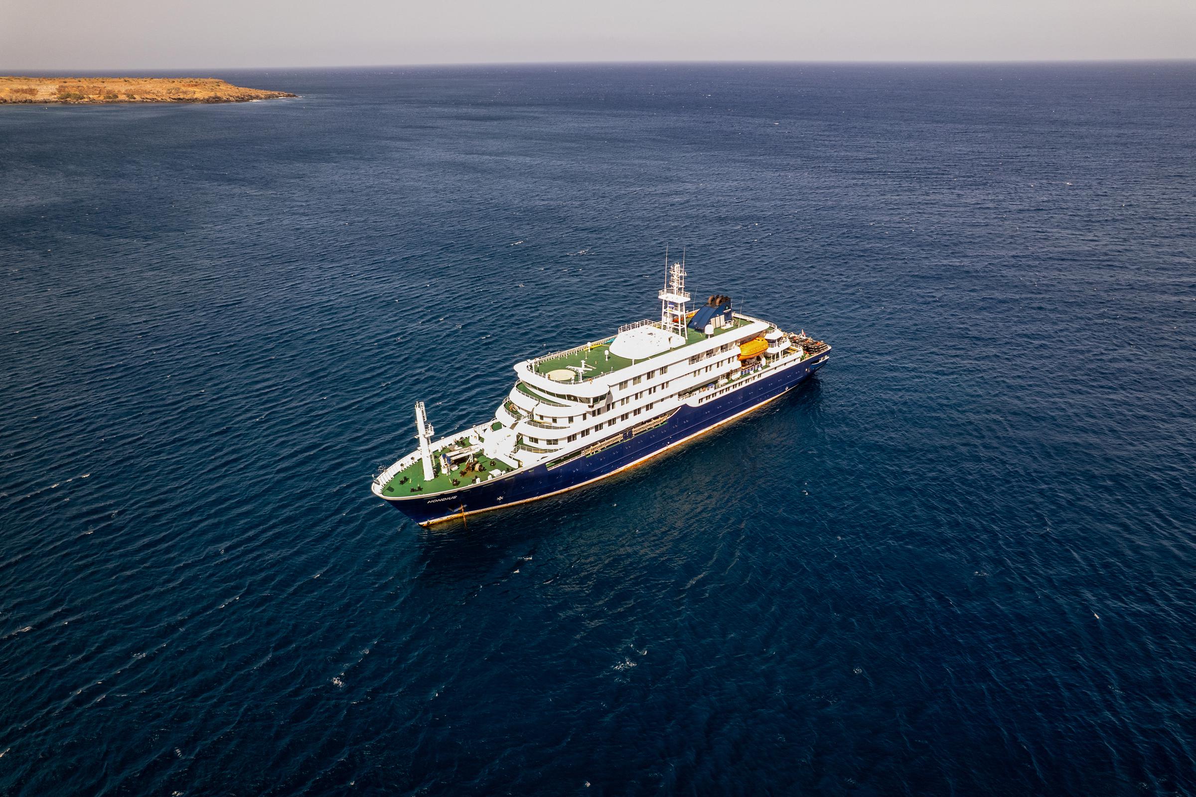 This aerial picture shows a general view of the cruise ship MV Hondius stationary off the port of Praia, the capital of Cape Verde, on 3 May 2026. | Source: Getty Images