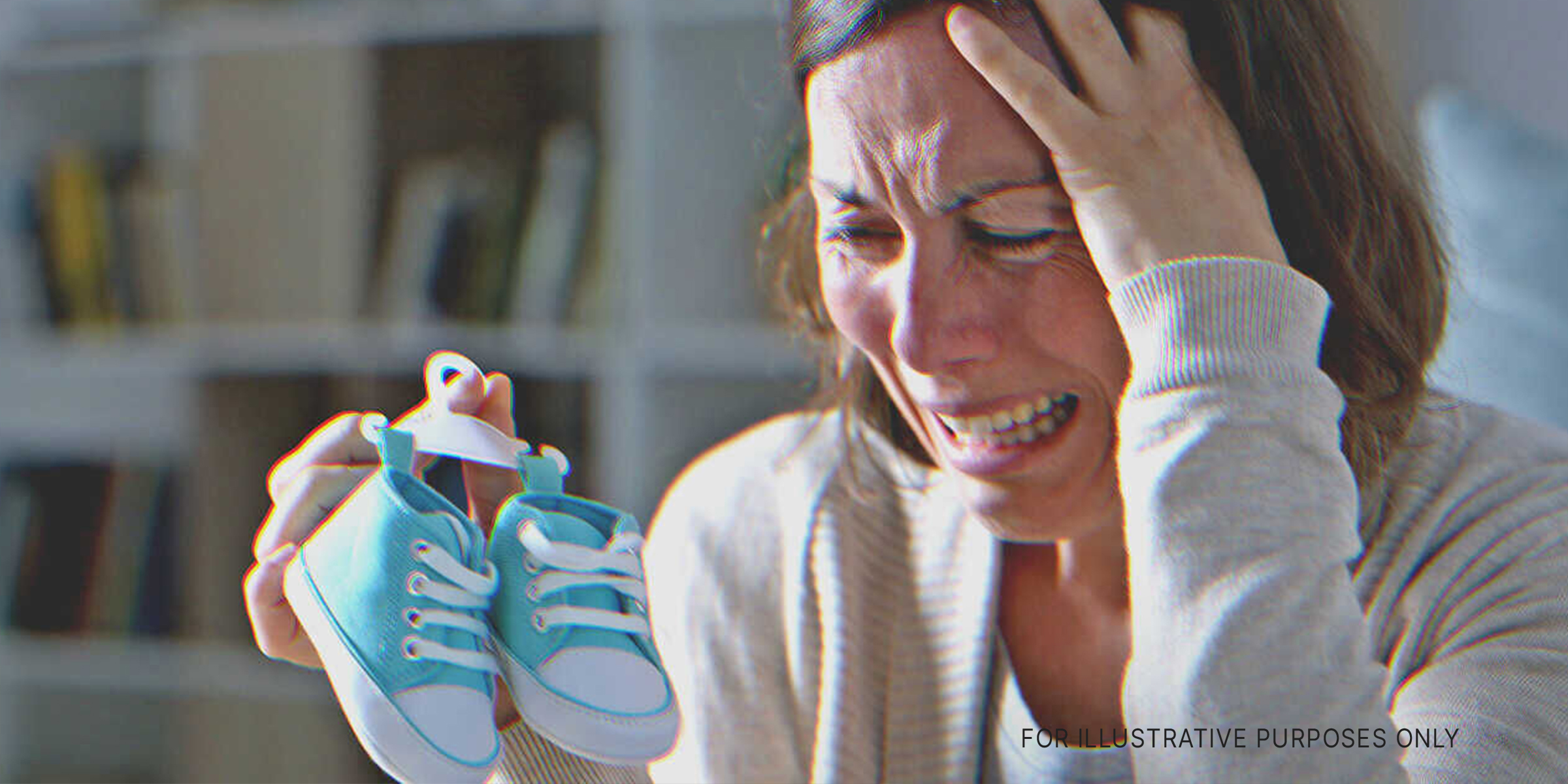 A woman holding baby shoes | Source: Shutterstock