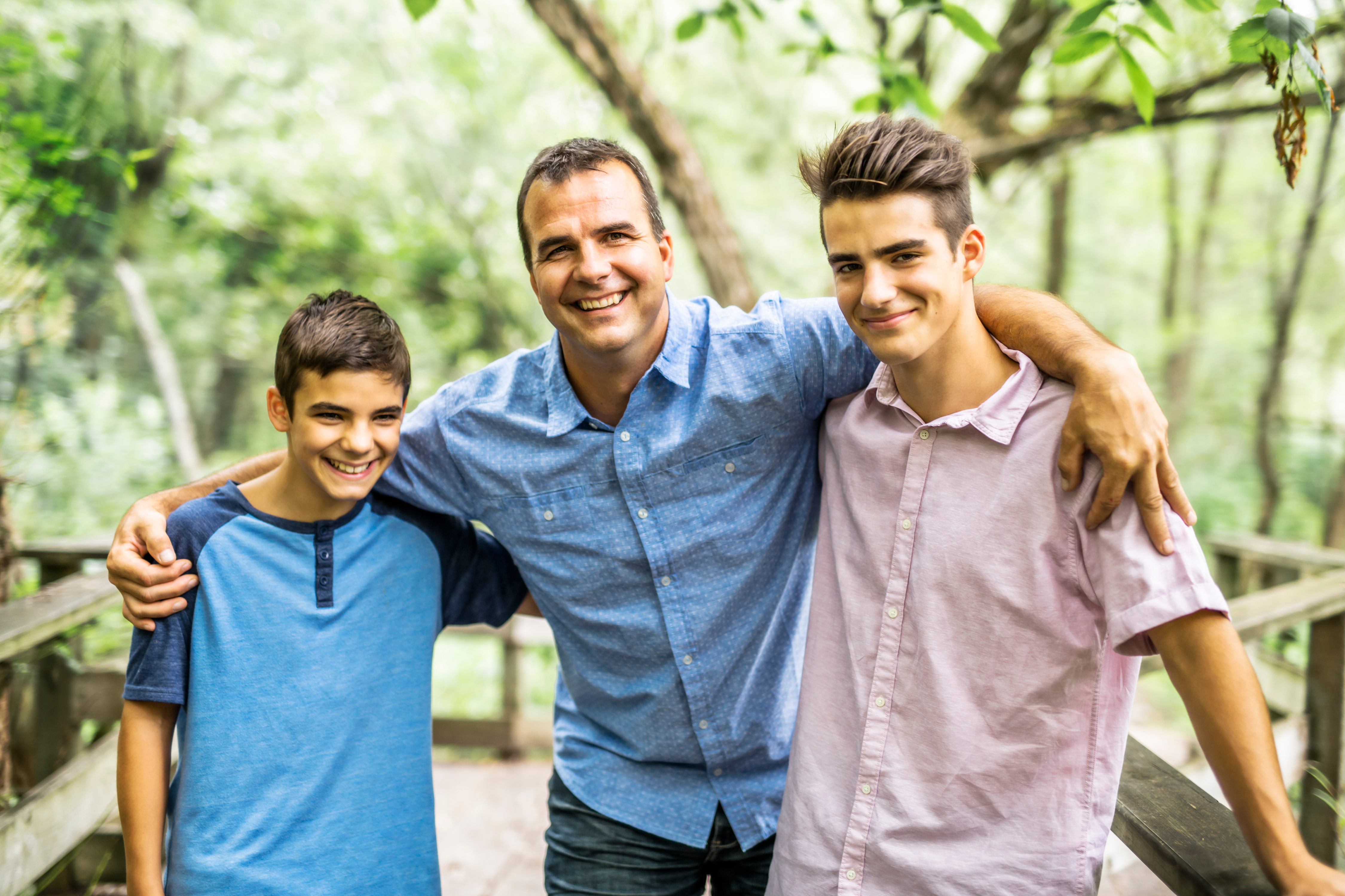 A man standing with two young boys | Source: Shutterstock