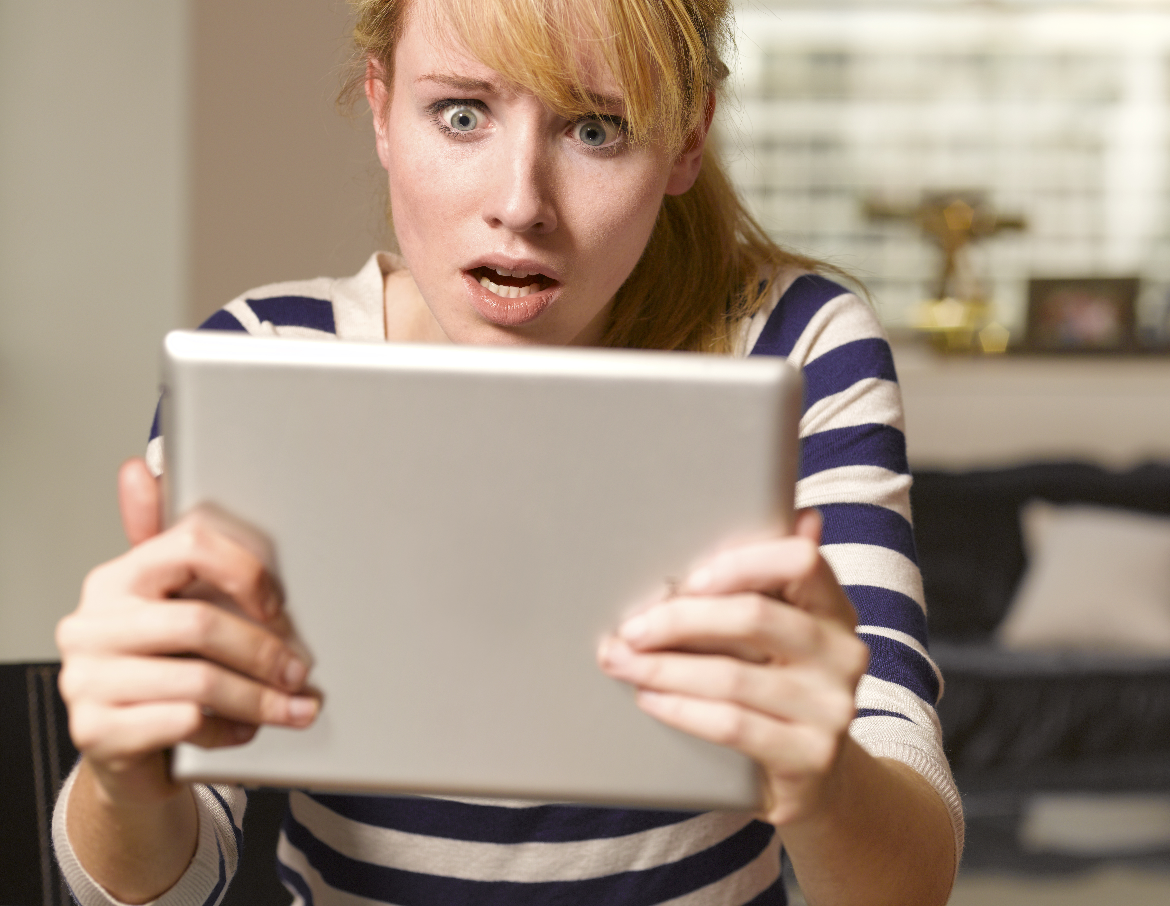 A shocked woman looking at a tablet | Source: Getty Images