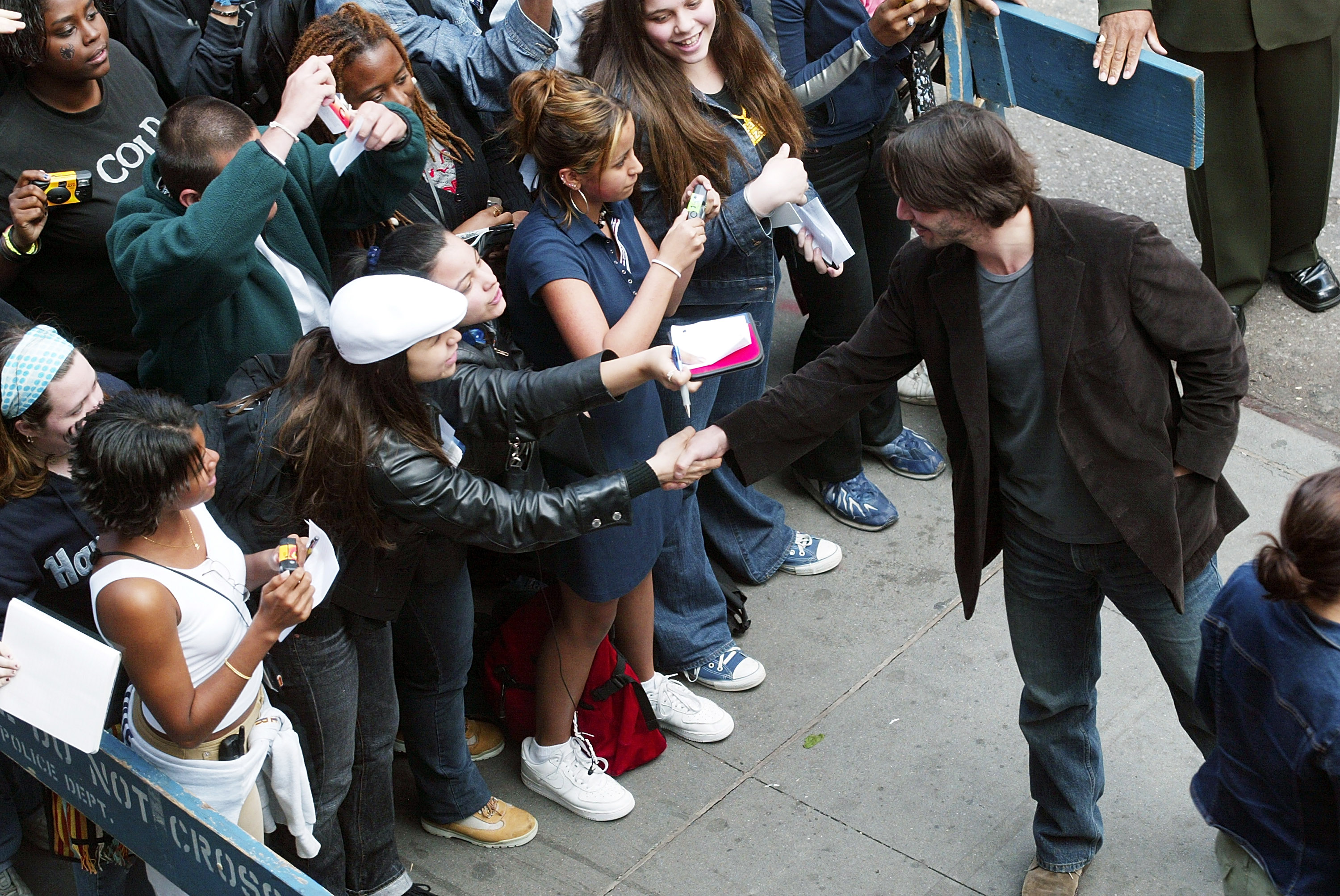 Keanu Reeves greets fans during a visit from the cast of "The Matrix Reloaded" in New York City, on May 13, 2003. | Source: Getty Images