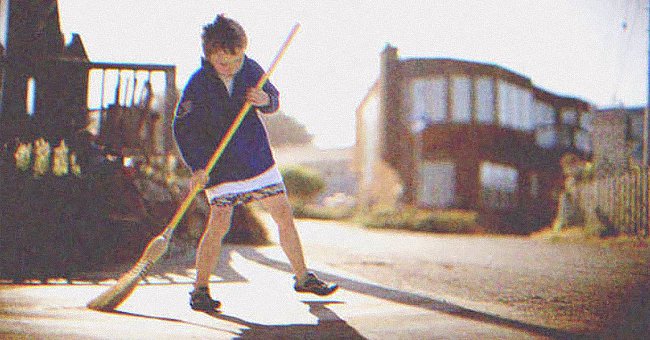 Boy sweeping the floor | Source: Shutterstock