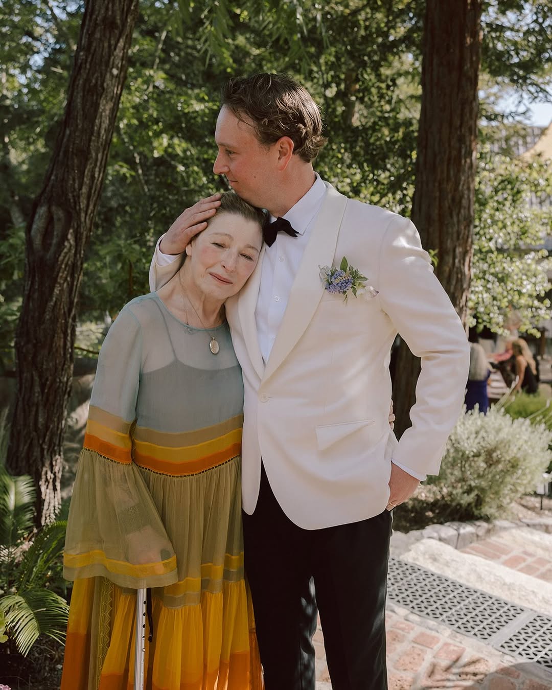 Tatum O'Neal leaning her head on Kevin McEnroe's shoulder at his wedding to Fern Cozine, from a post dated July 20, 2025 | Source: Instagram/tatum__oneal