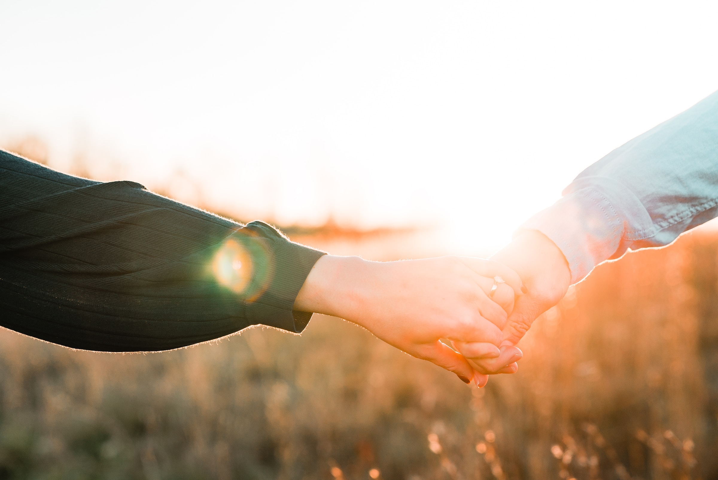 A couple pictured holding hands in the sun | Source: Unsplash