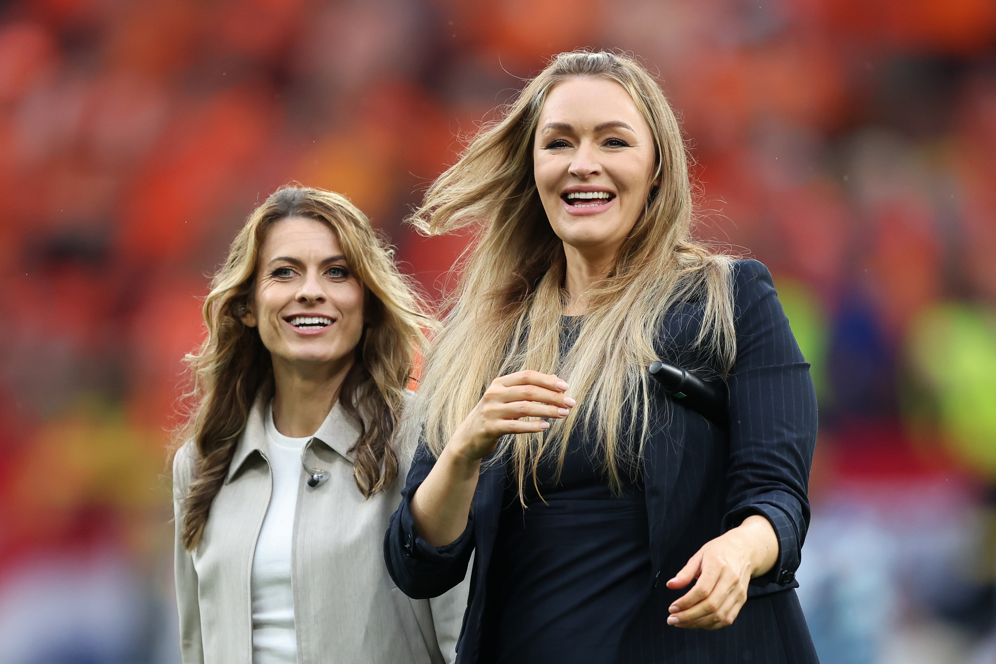 Karen Carney and Laura Woods react prior to the UEFA EURO 2024 semi-final match between Netherlands and England at Football Stadium Dortmund on 10 July 2024 in Dortmund, Germany. | Source: Getty Images