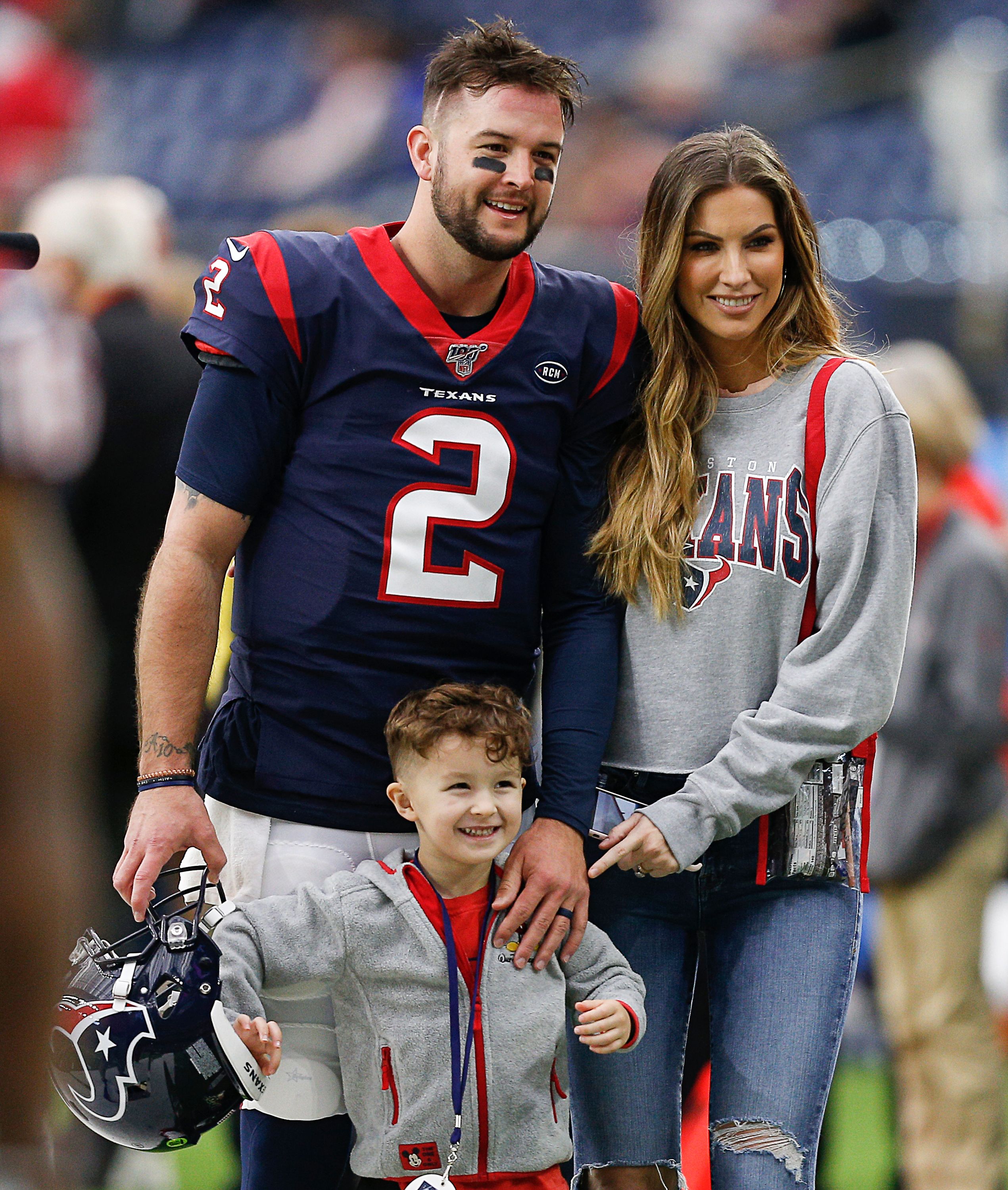  AJ McCarron, his wife Katherine Webb-McCarron and their son Tripp at NRG Stadium in 2019 in Houston, Texas | Source: Getty Images