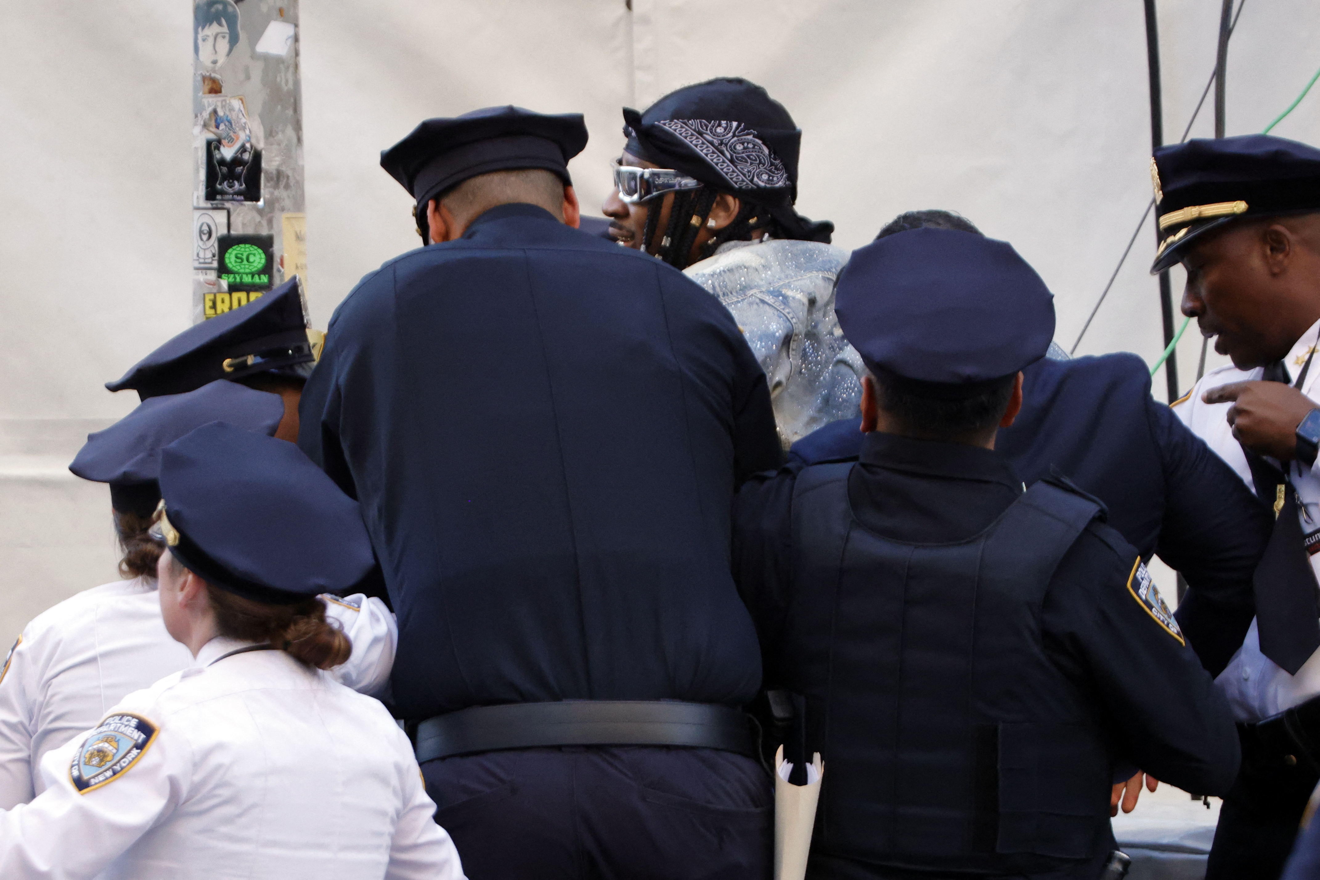 NYPD officers detain a man after he tried to break into the red carpet of the 2026 Met Gala | Source: Getty Images
