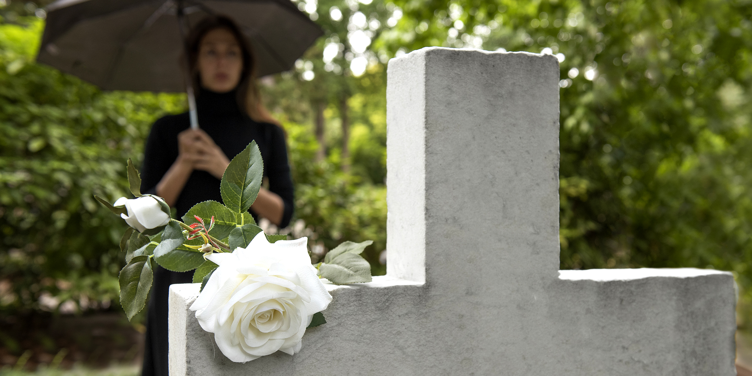 A woman standing near a grave | Source: freepik.com/freepik