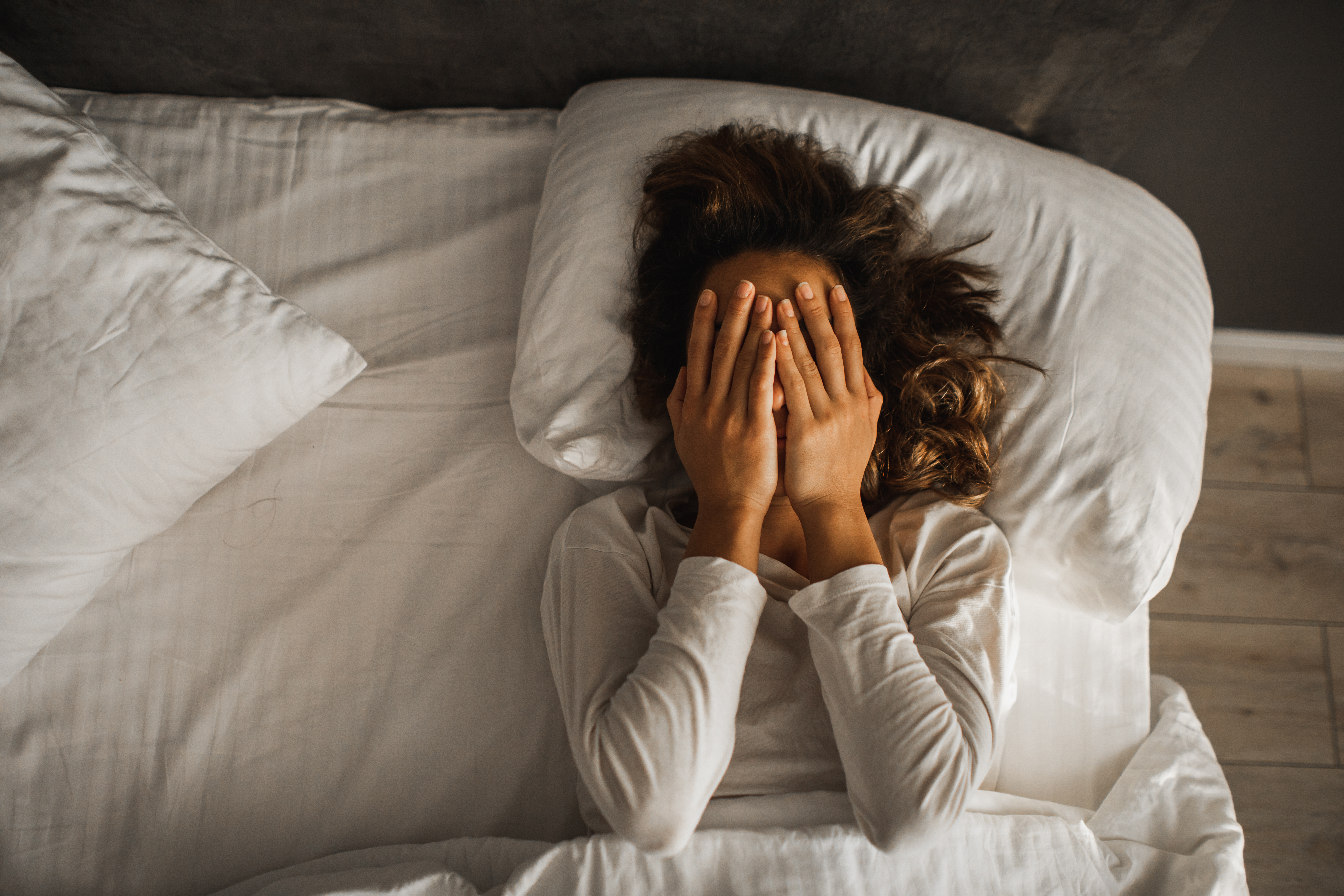 A sad woman in bed | Source: Getty Images