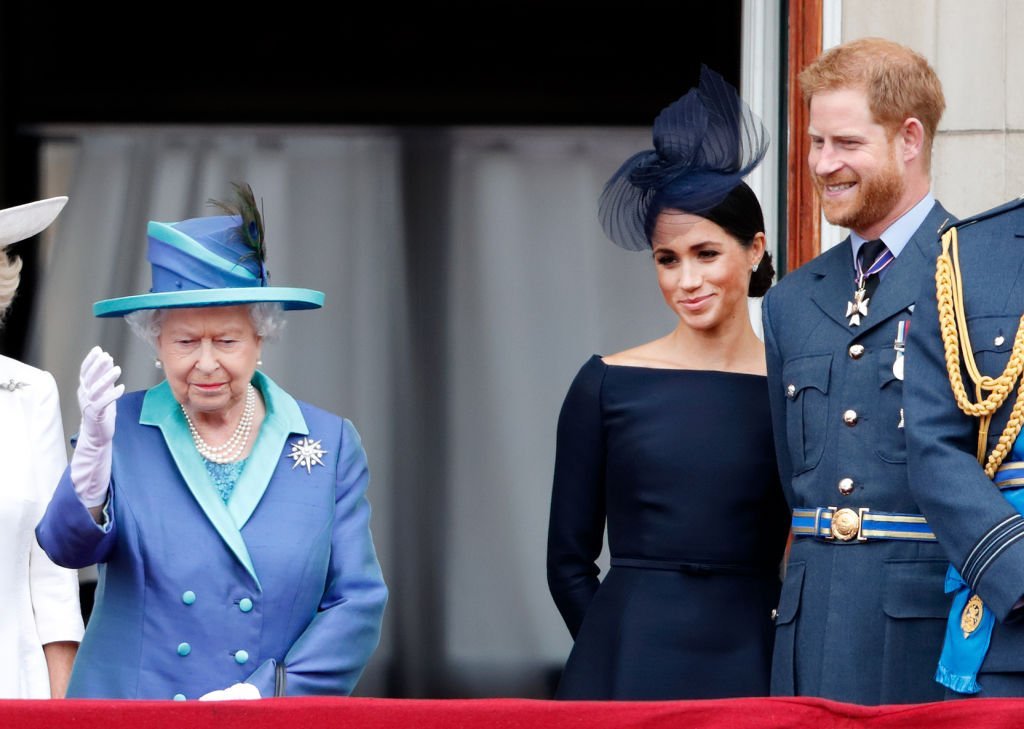 Queen Elizabeth and Meghan Markle stand on the balcony at Buckingham Palace as they watched a flypast marking the centenary of the Royal Air Force on July 10, 2018, in London, England. | Photo: Getty Images
