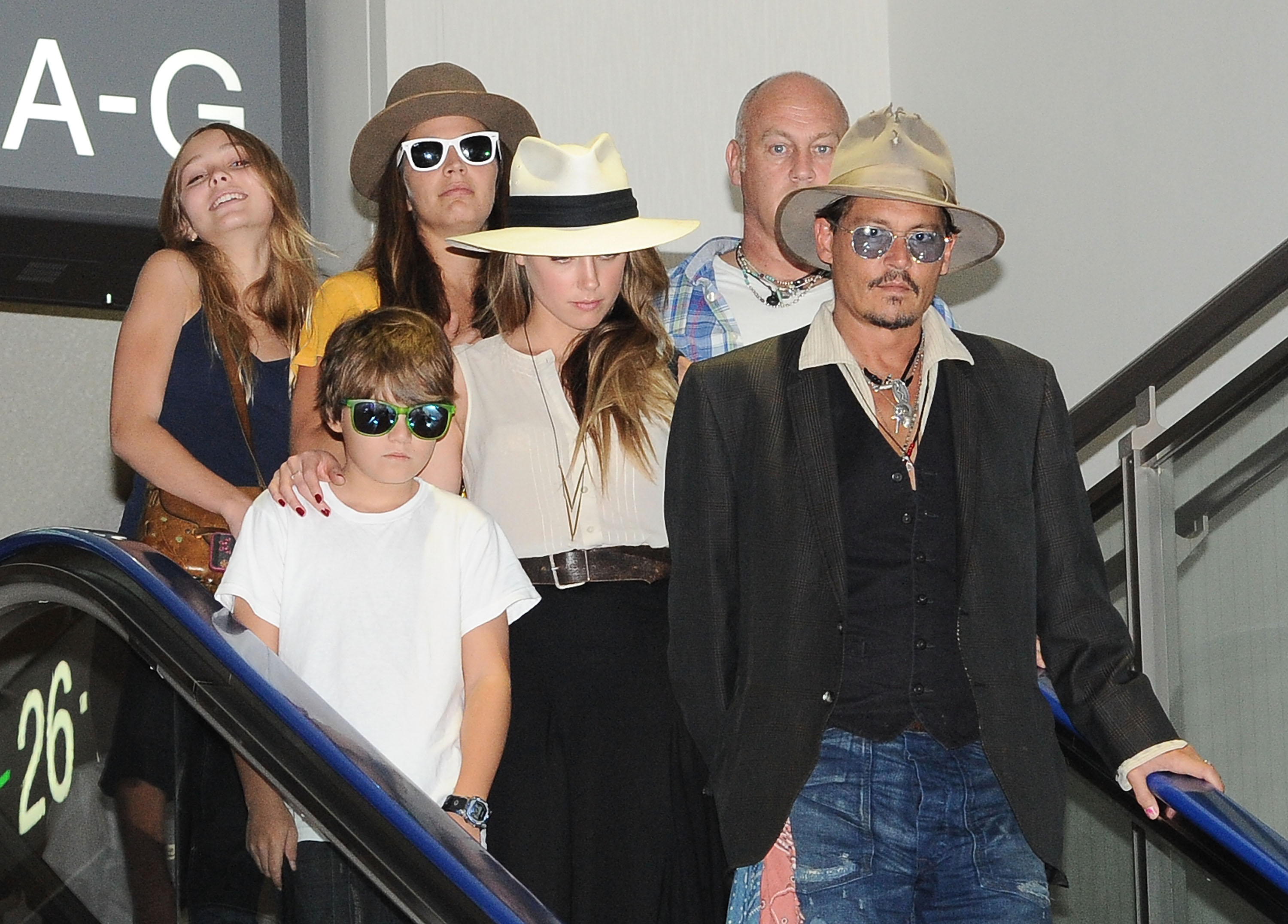Johnny Depp, Amber Heard, Jack Depp, and Lily Rose Melody Depp are spotted departing from Narita International Airport on July 18, 2013, in Narita, Japan | Source: Getty Images