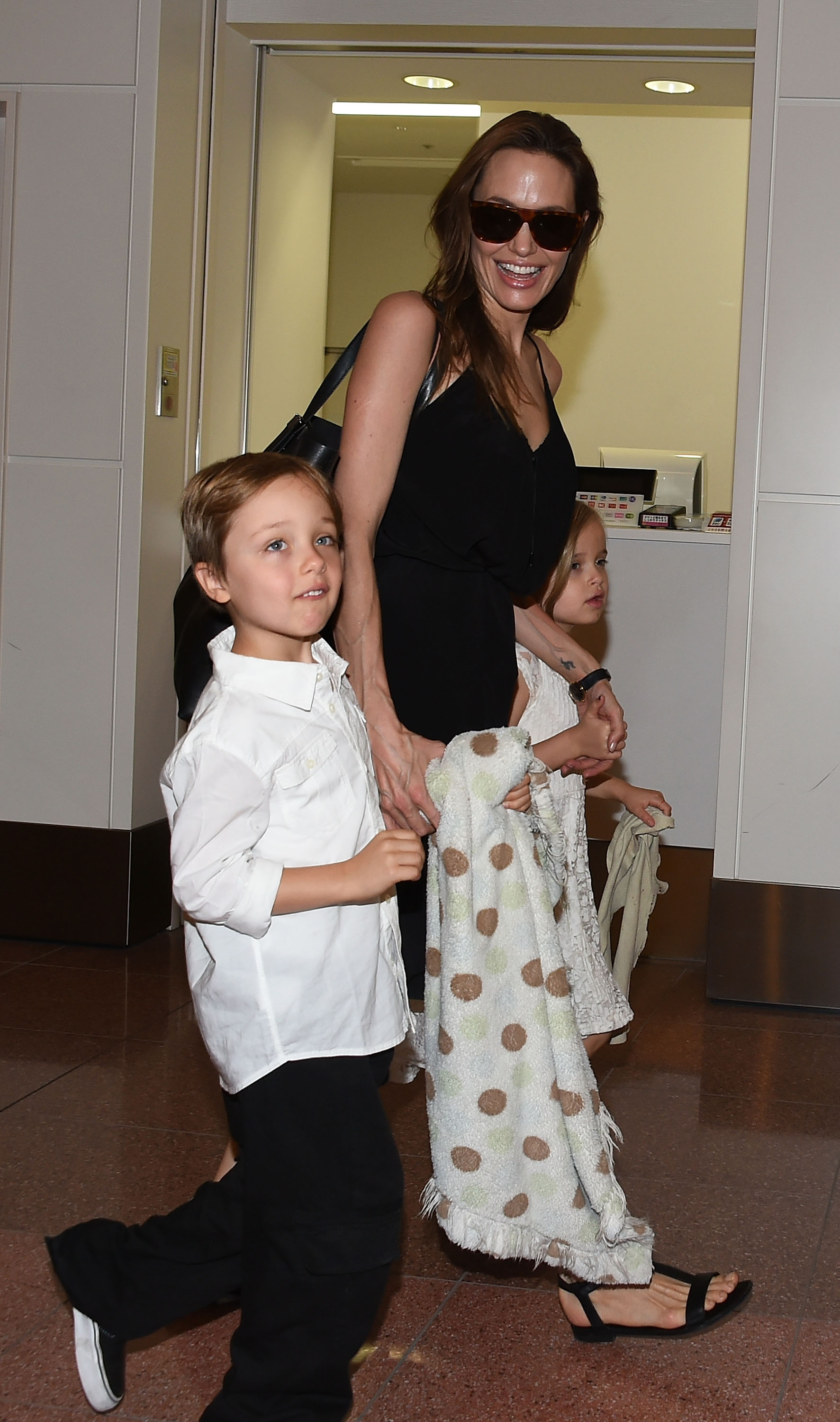 Knox Jolie-Pitt, Angelina Jolie, and Vivienne Jolie are seen upon arrival at Haneda Airport on June 21, 2014, in Tokyo, Japan.
